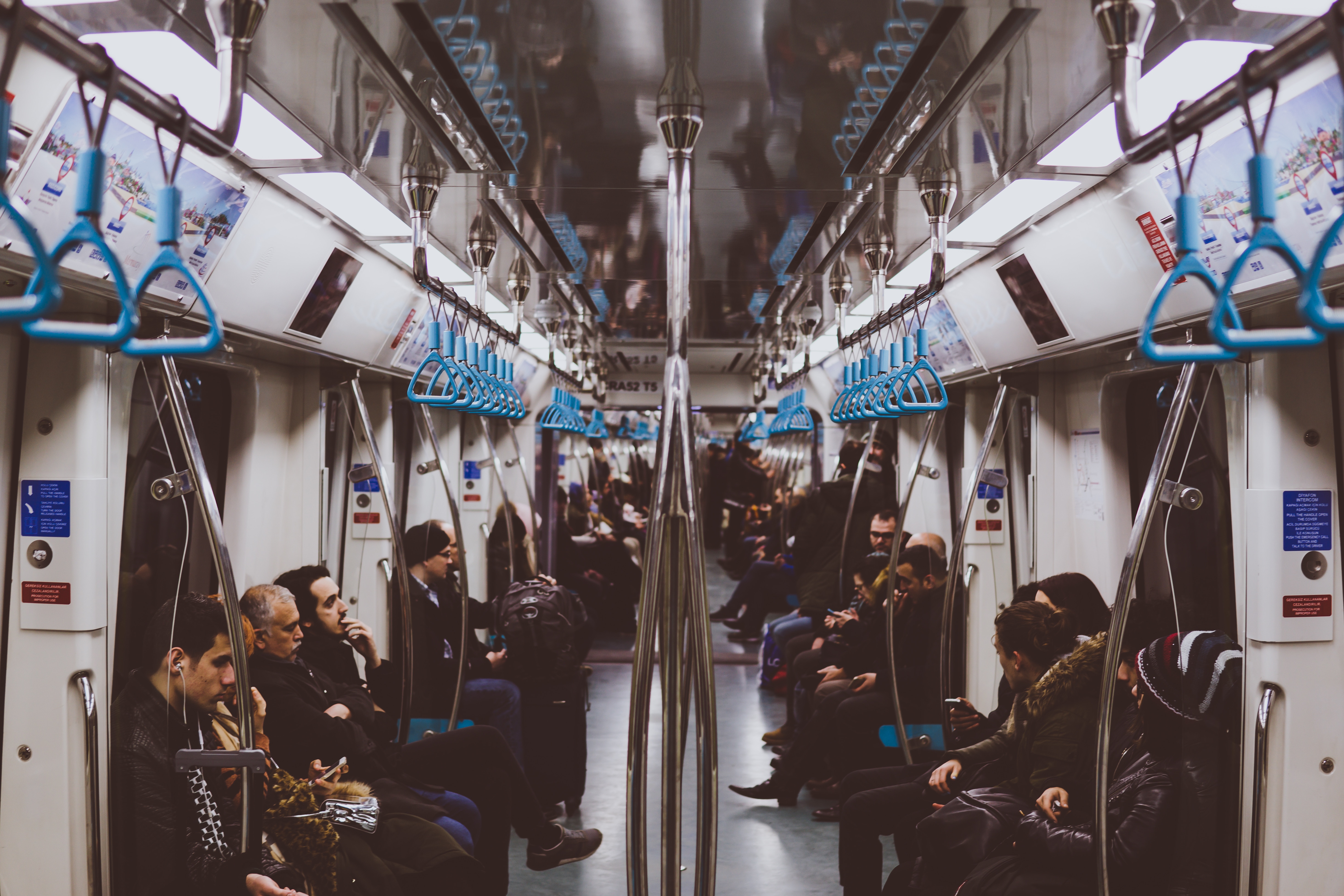 Commuters on a busy subway train HD Wallpaper
