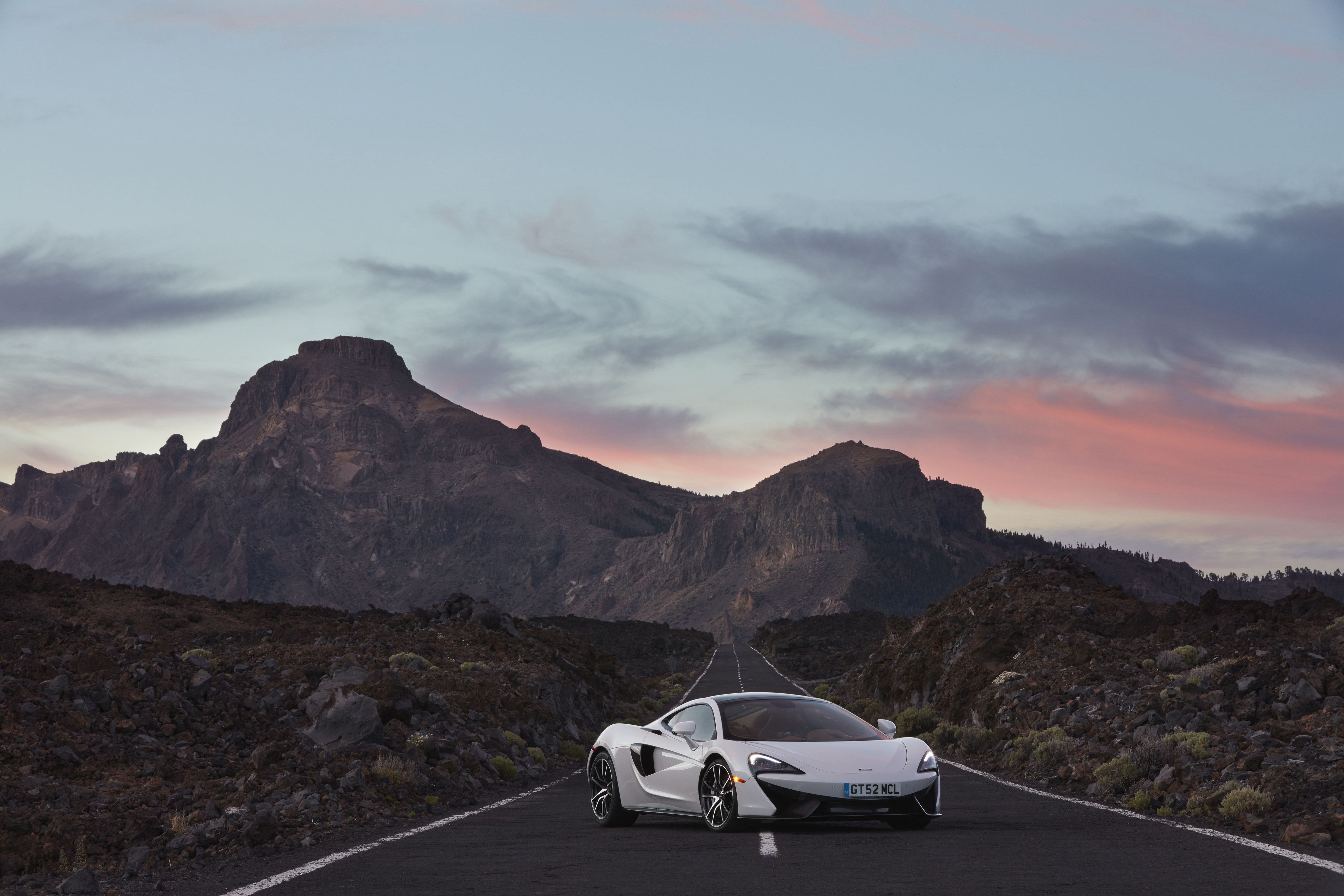 White McLaren 570S on a mountain road HD Wallpaper