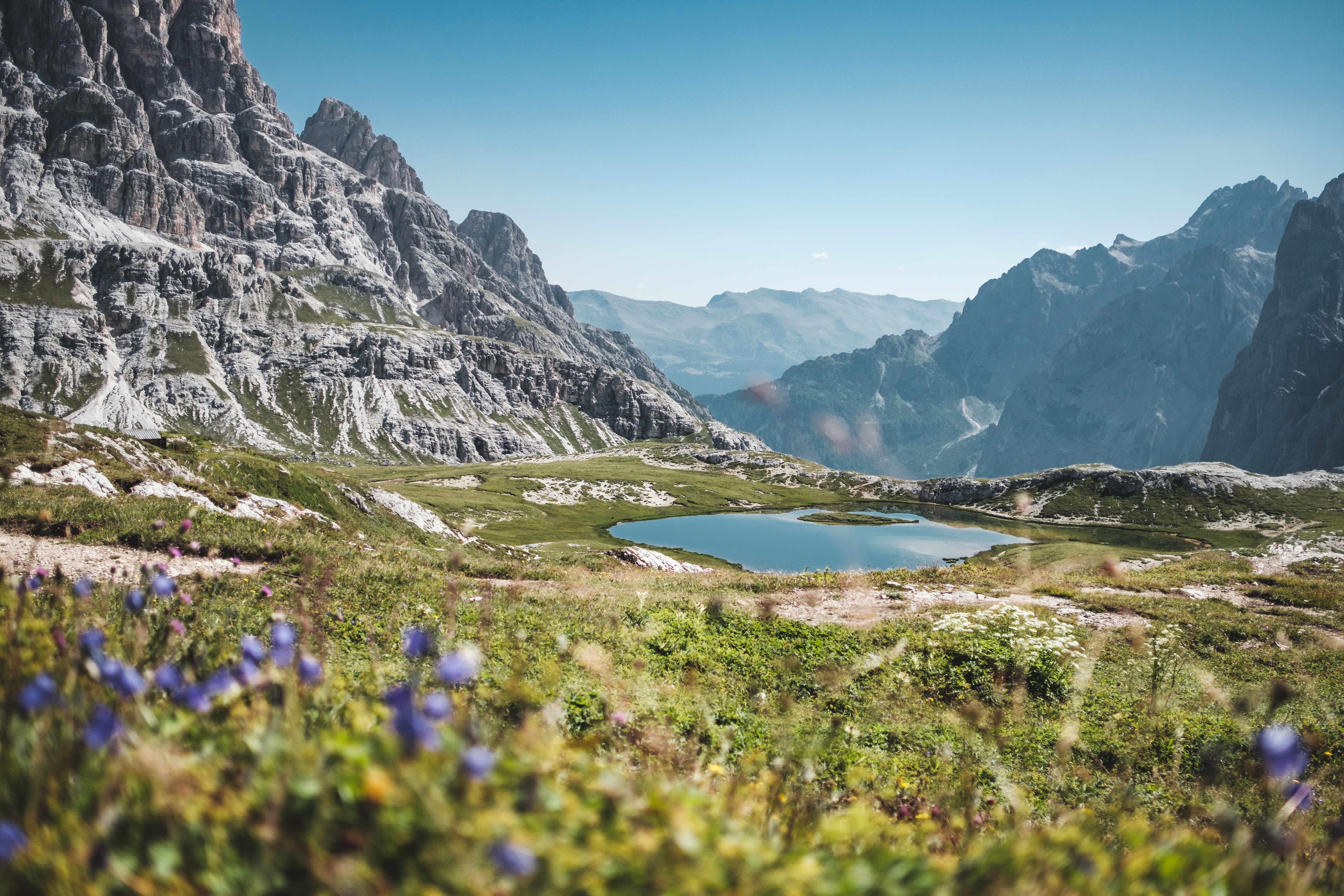 Serene Dolomite Mountain Valley with Pond and Wildflowers HD Wallpaper