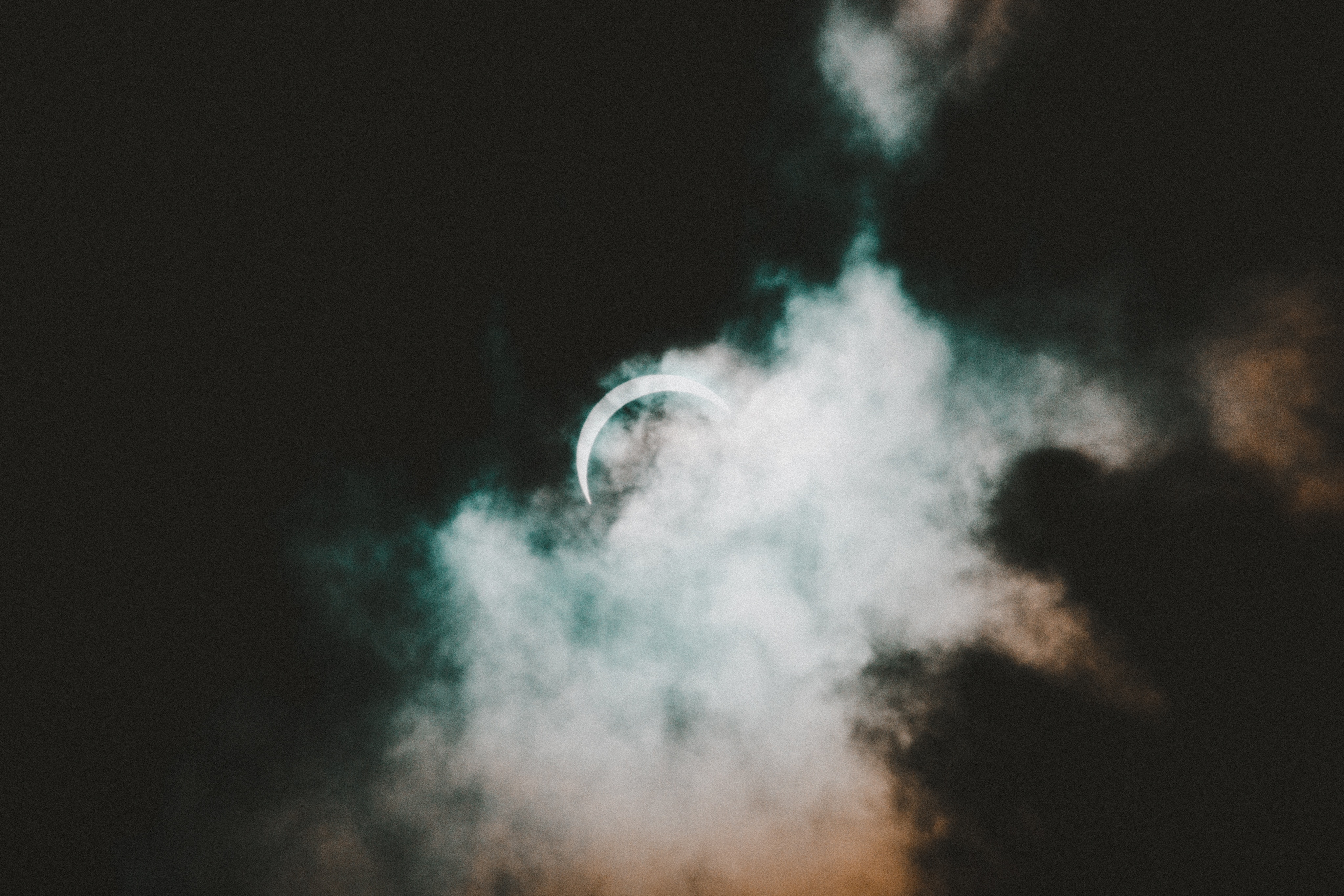 Solar eclipse behind clouds HD Wallpaper