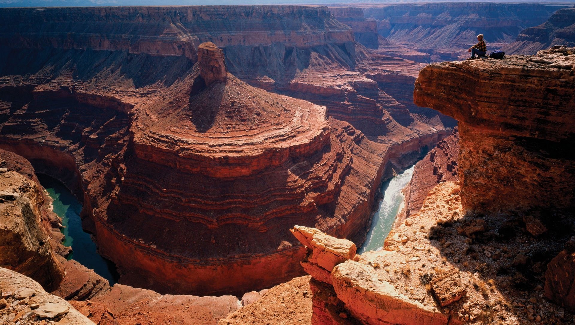 Grand Canyon with a person sitting on the edge HD Wallpaper