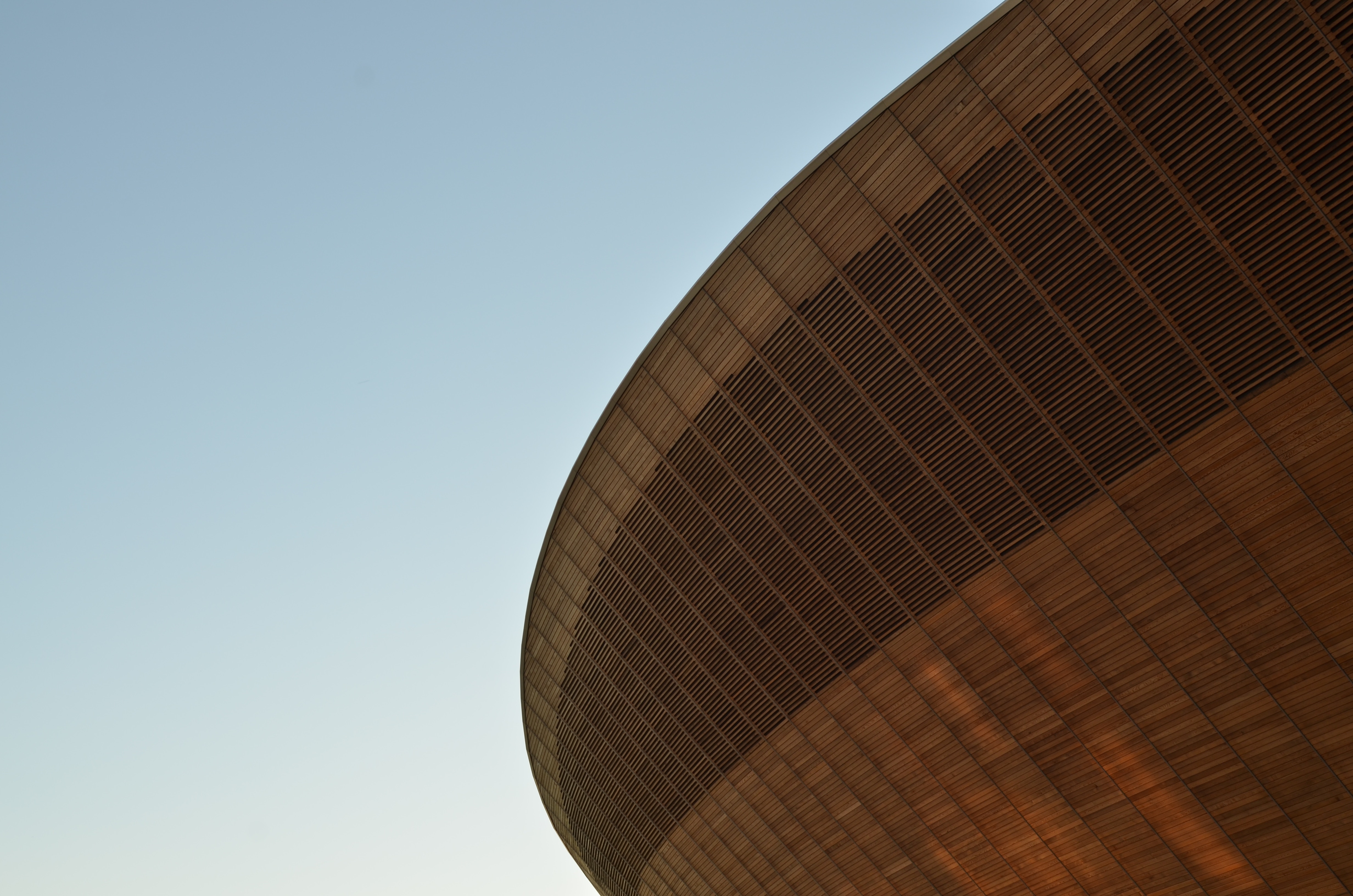 Wooden structure of a velodrome against a clear sky HD Wallpaper