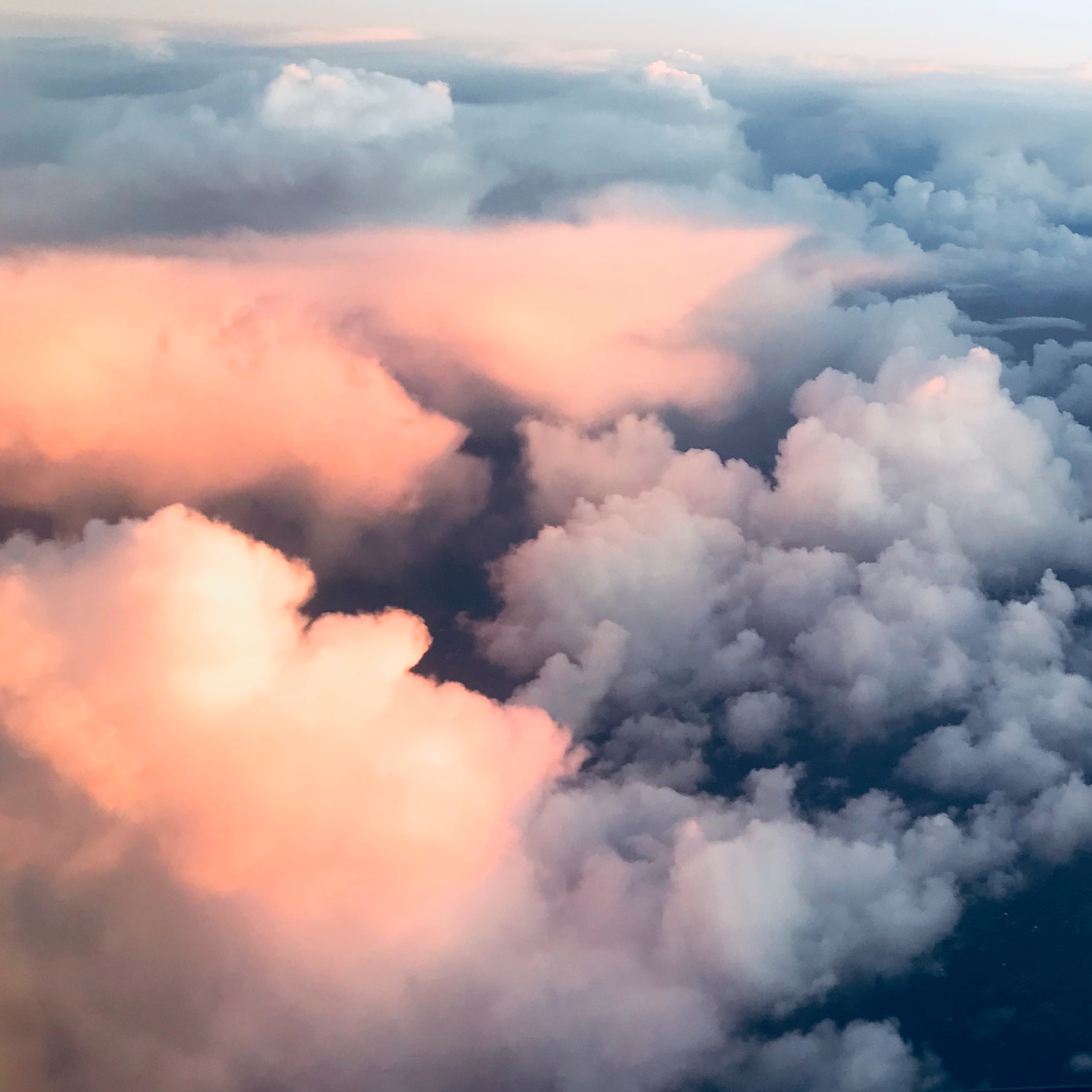Pink and blue clouds seen from an airplane HD Wallpaper