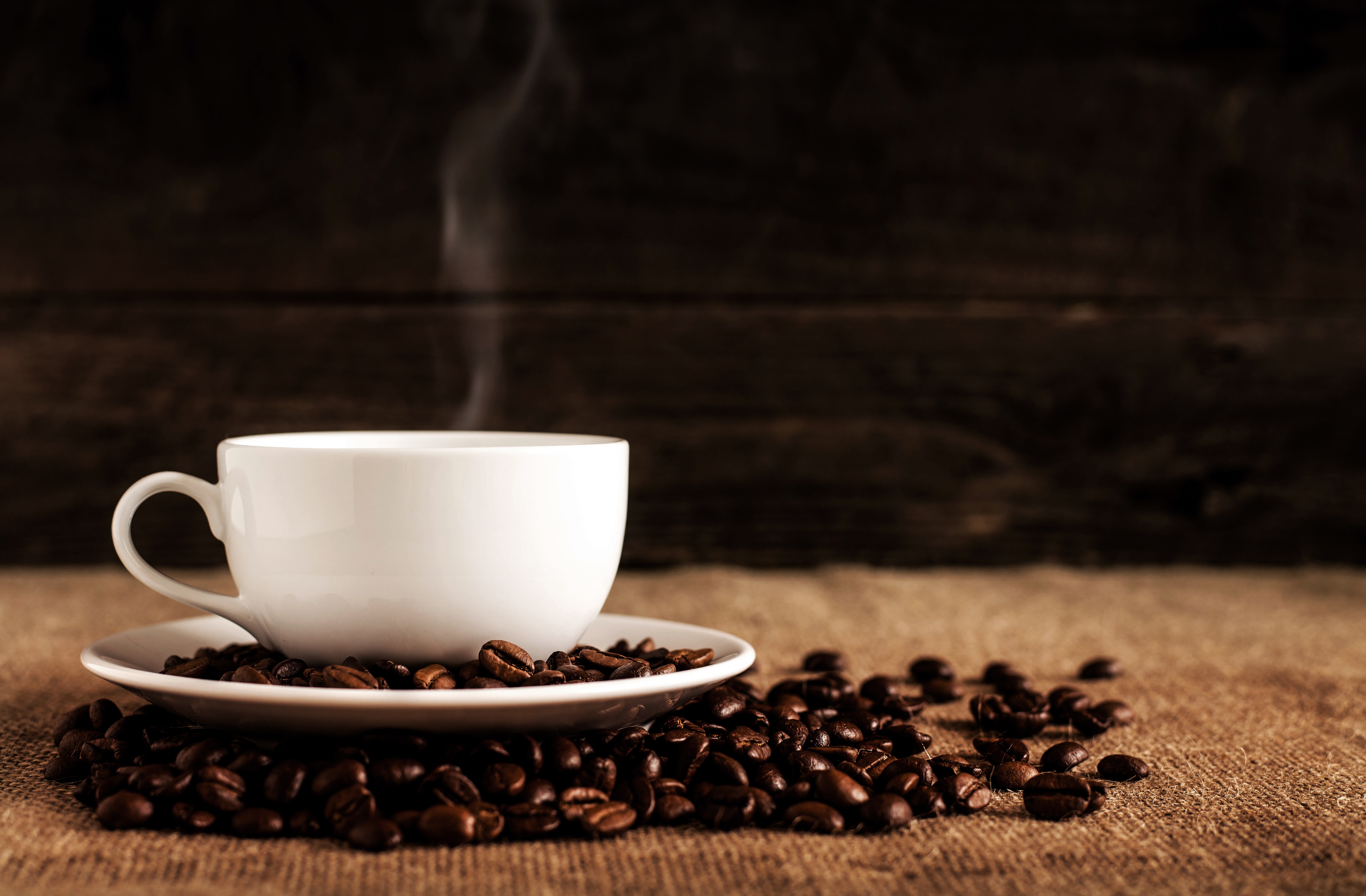 White coffee cup on saucer with coffee beans HD Wallpaper