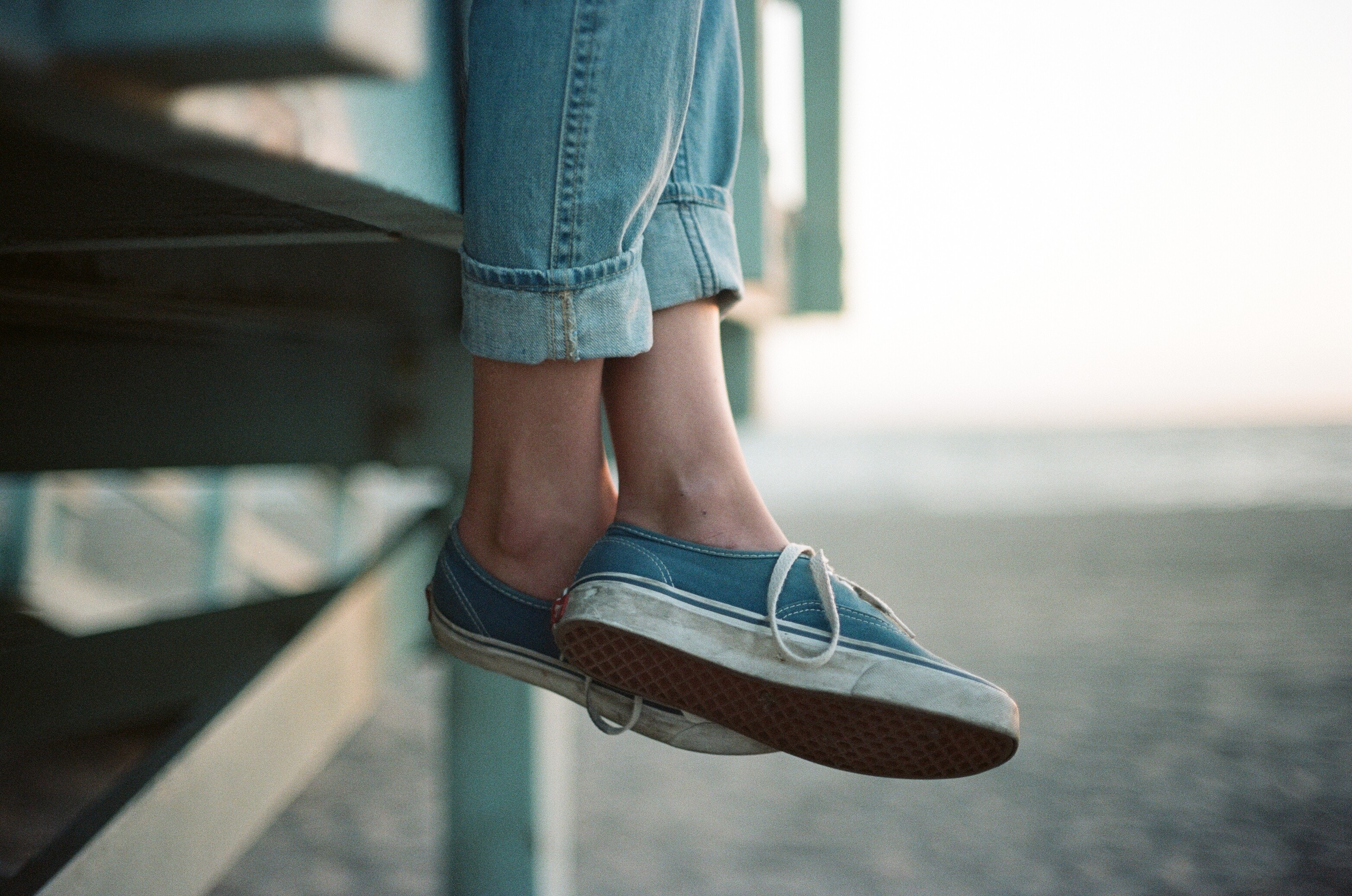 Person wearing blue Vans shoes and jeans HD Wallpaper