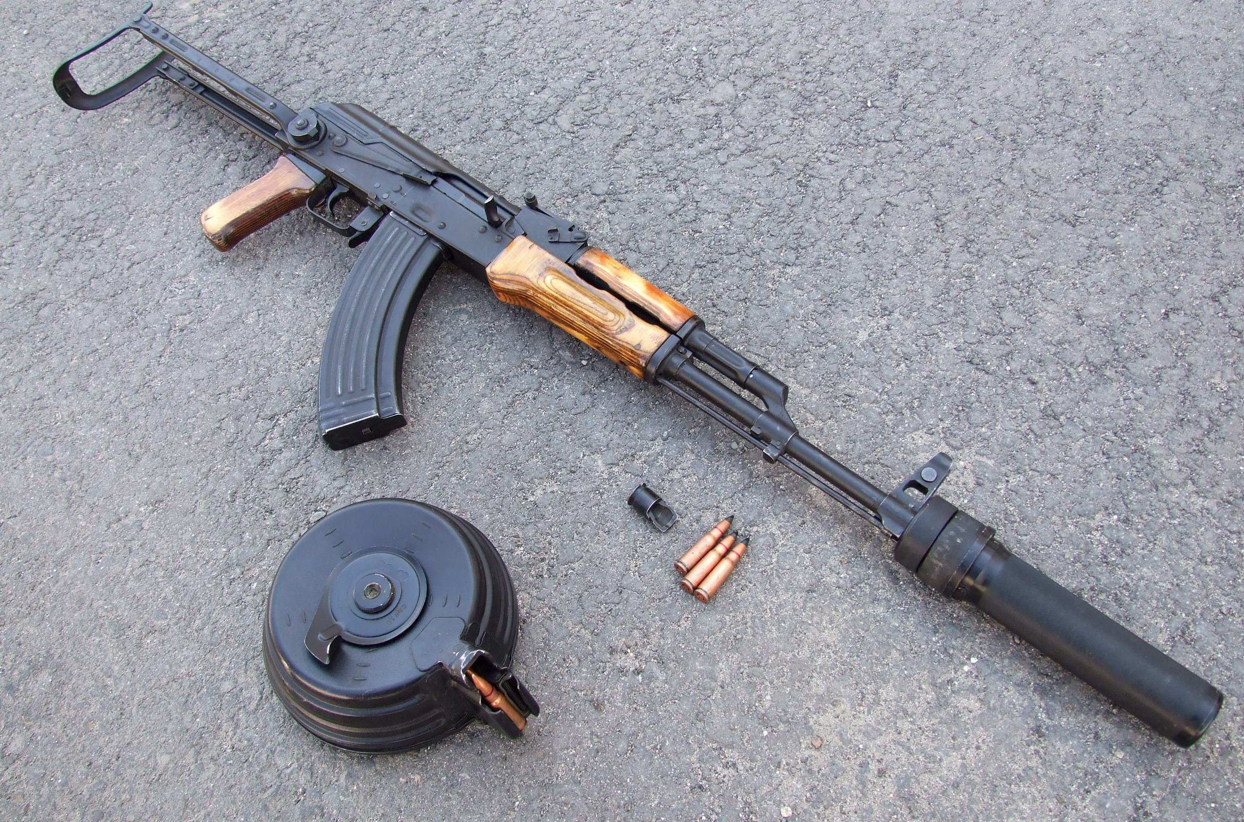 AK-47 rifle with drum magazine and suppressor HD Wallpaper