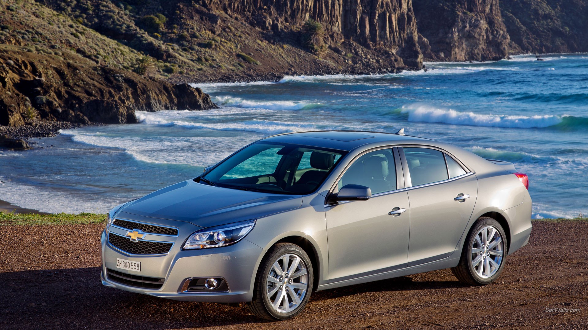 Silver Chevrolet Malibu parked by the ocean HD Wallpaper
