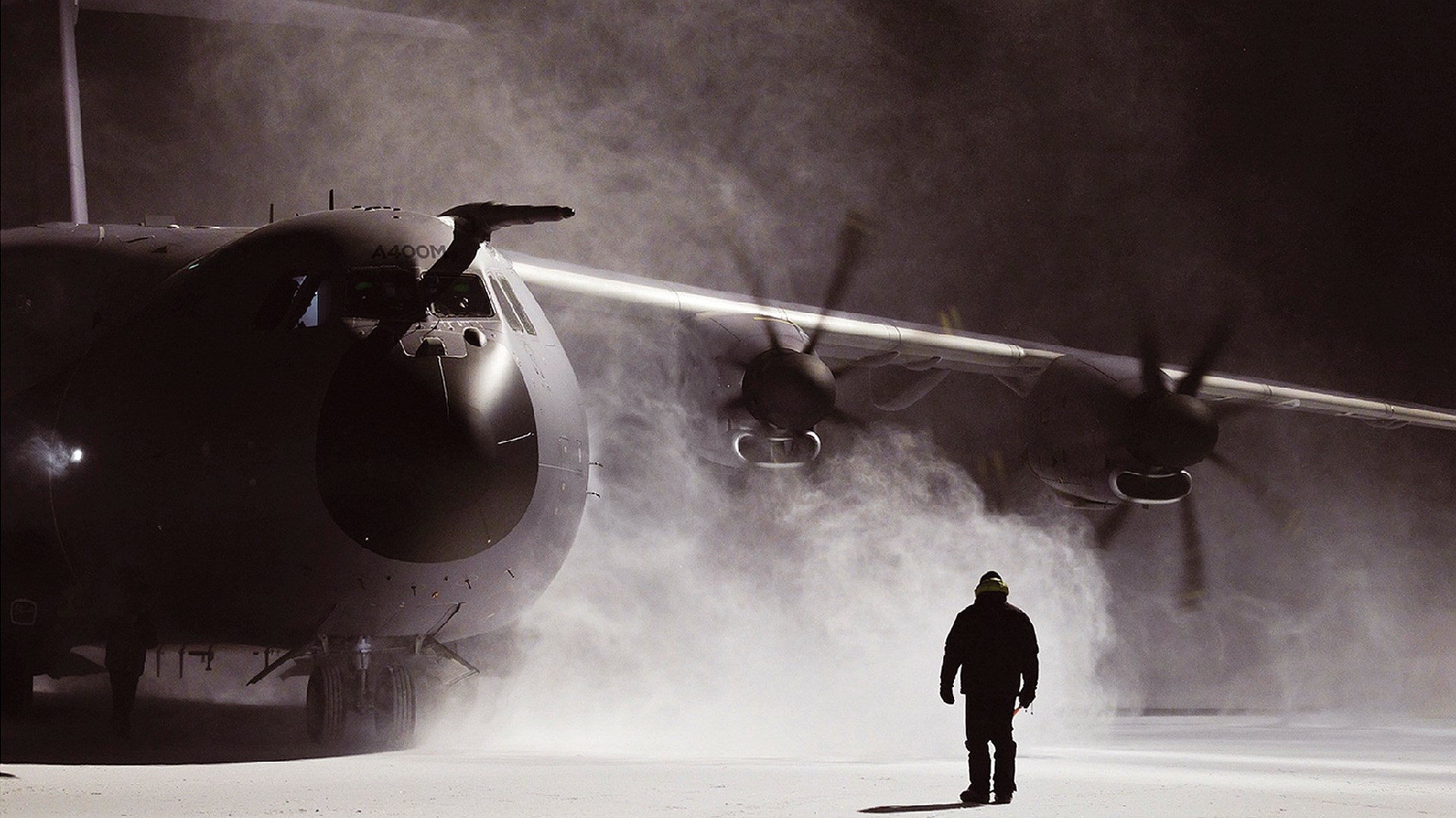 Airbus A400M on a snowy tarmac at night HD Wallpaper