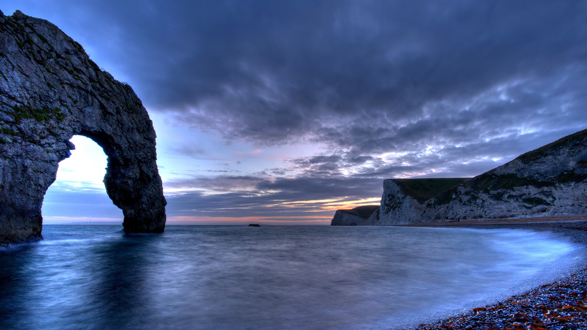 Seascape with rock arch and cliffs at dusk HD Wallpaper