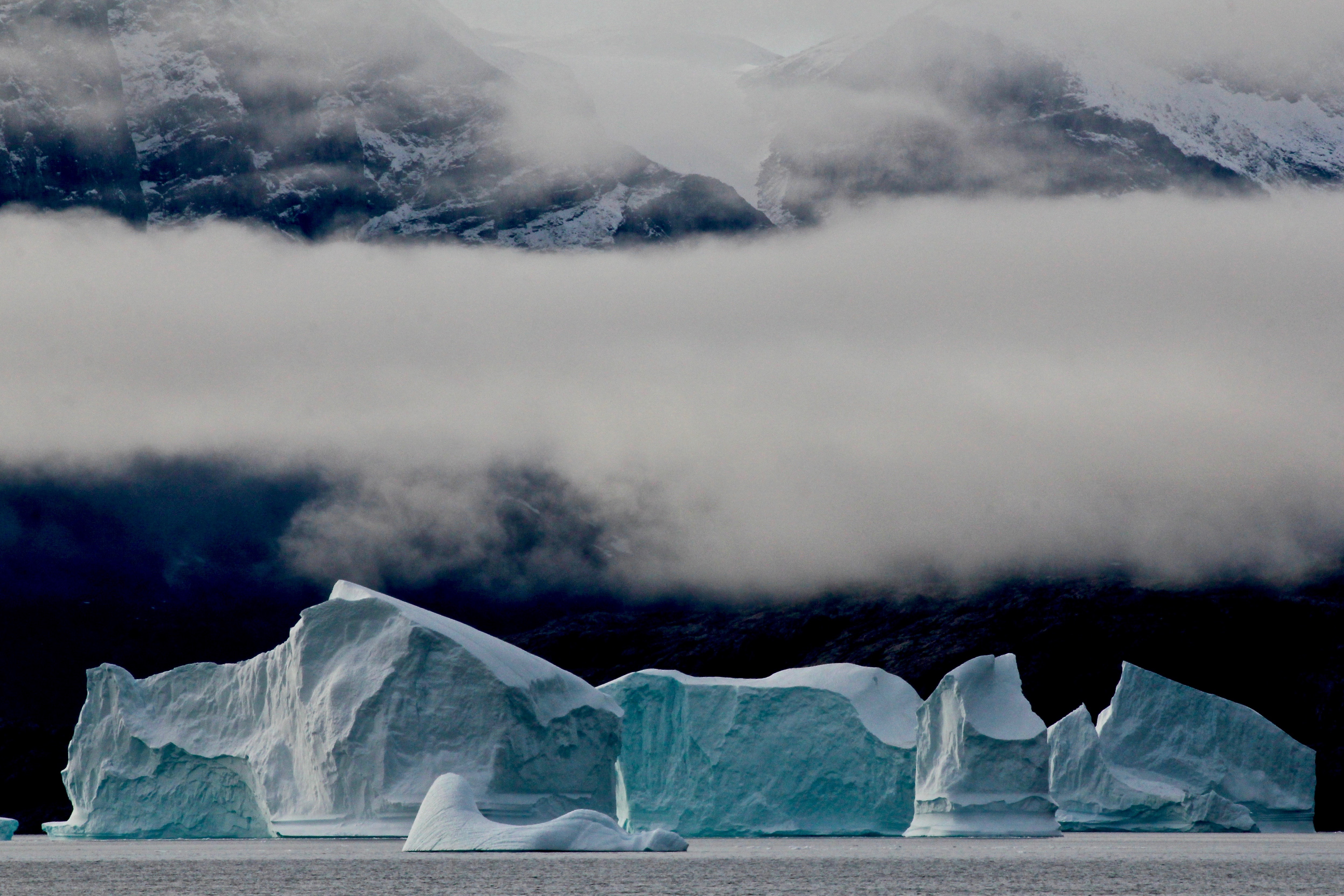 Icebergs in Greenland with mountains and clouds HD Wallpaper