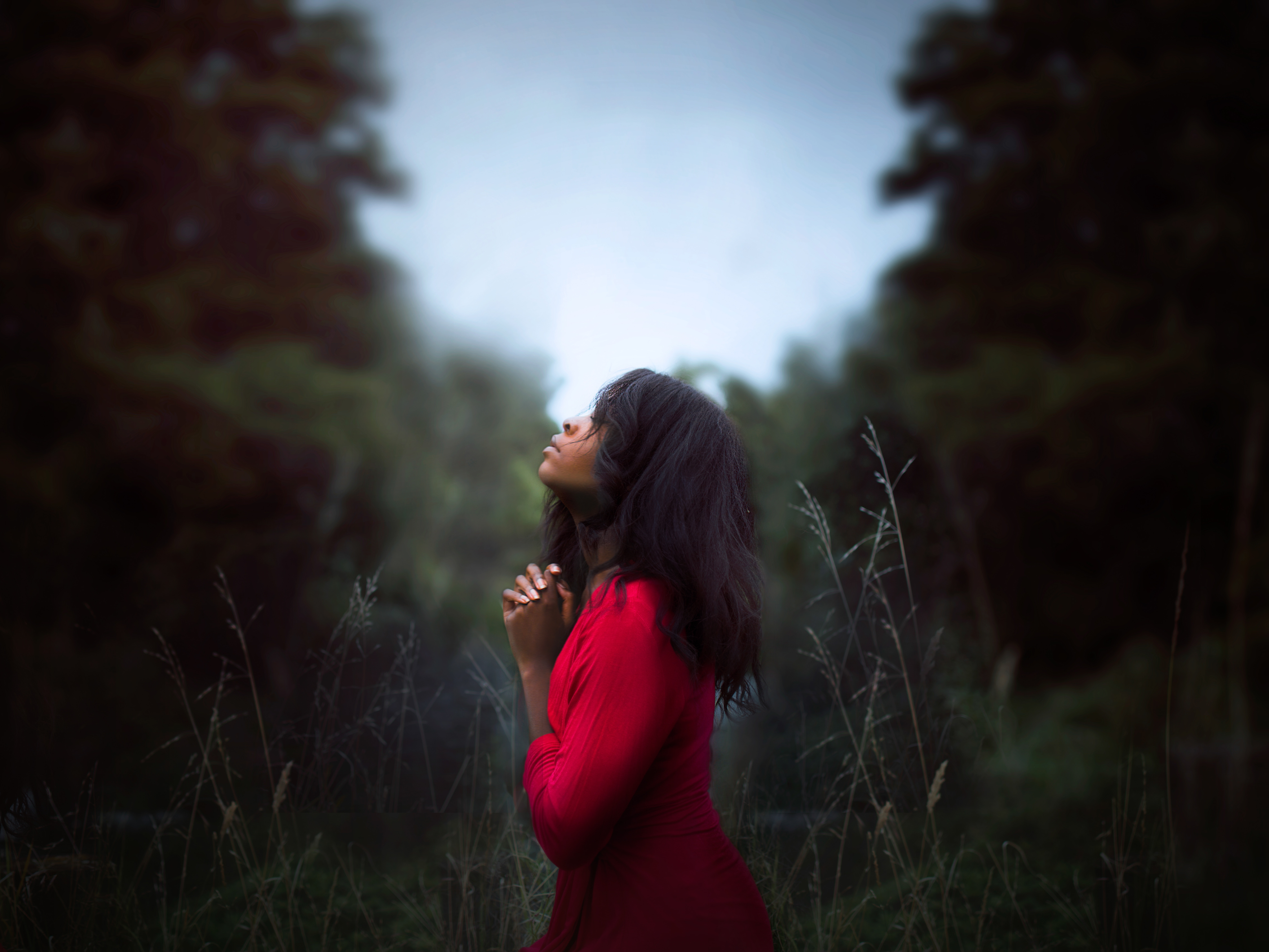 Woman Praying by Riverbank in Forest HD Wallpaper