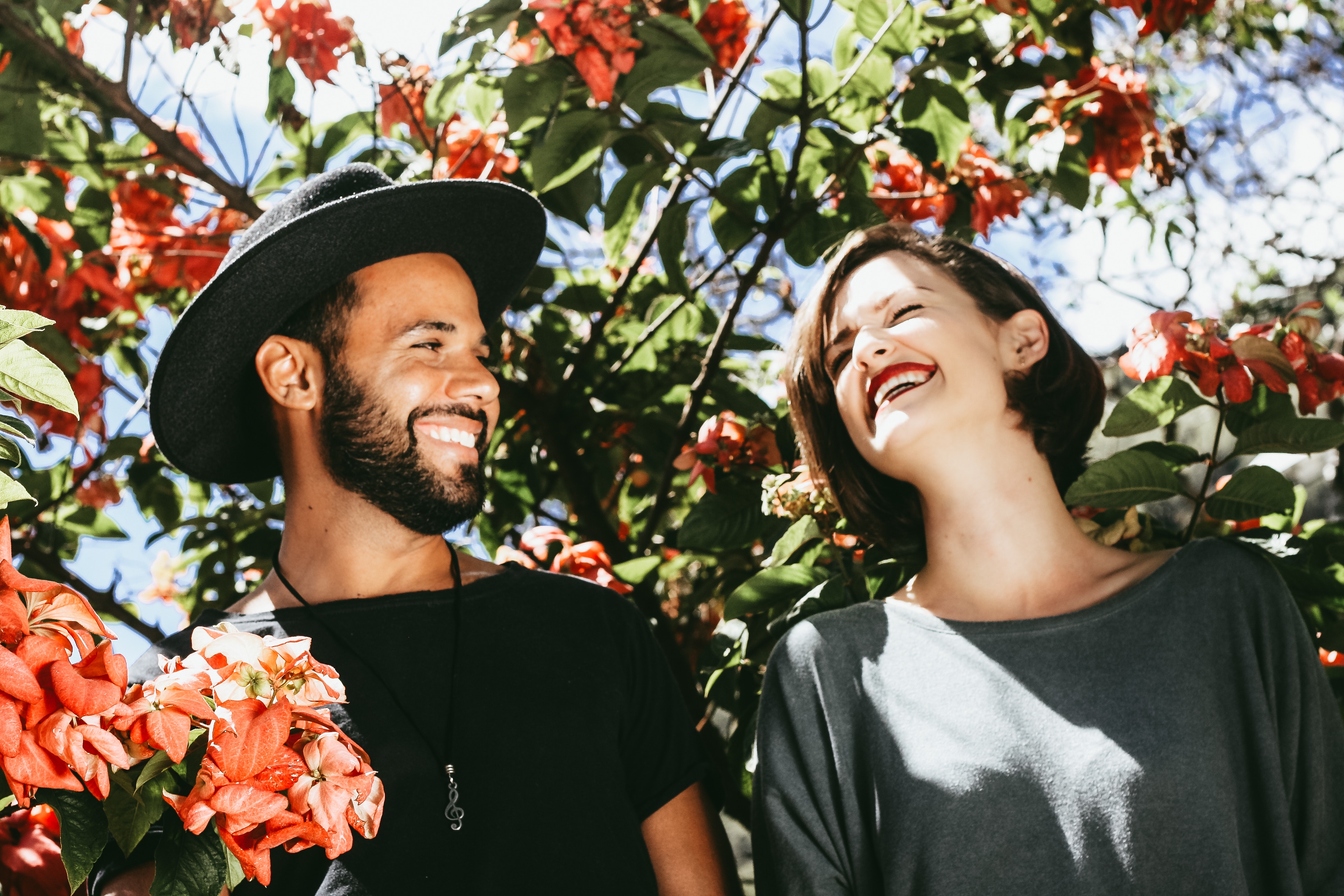 Couple laughing among flowers HD Wallpaper