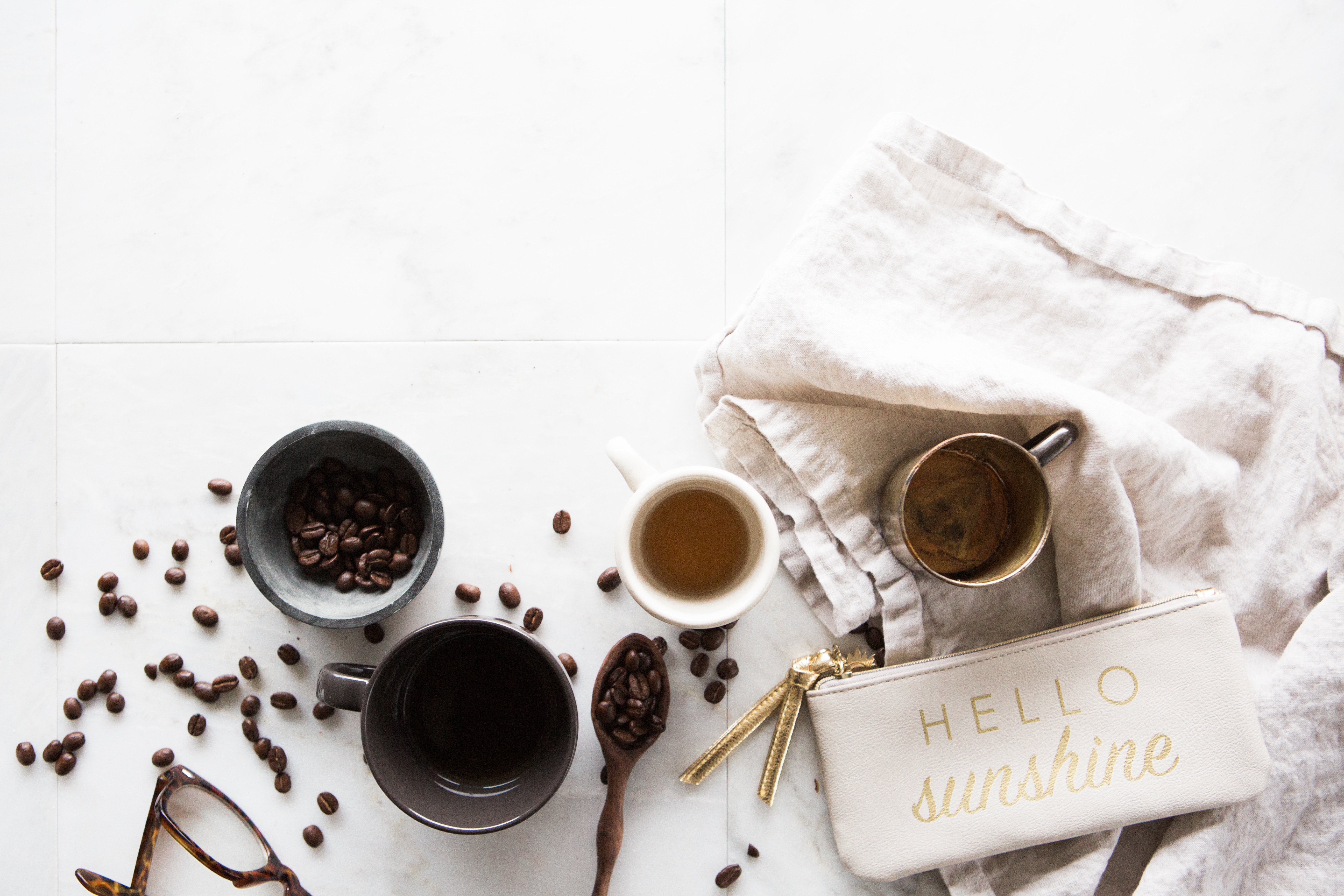Flat lay of coffee beans, cups, and a bag HD Wallpaper