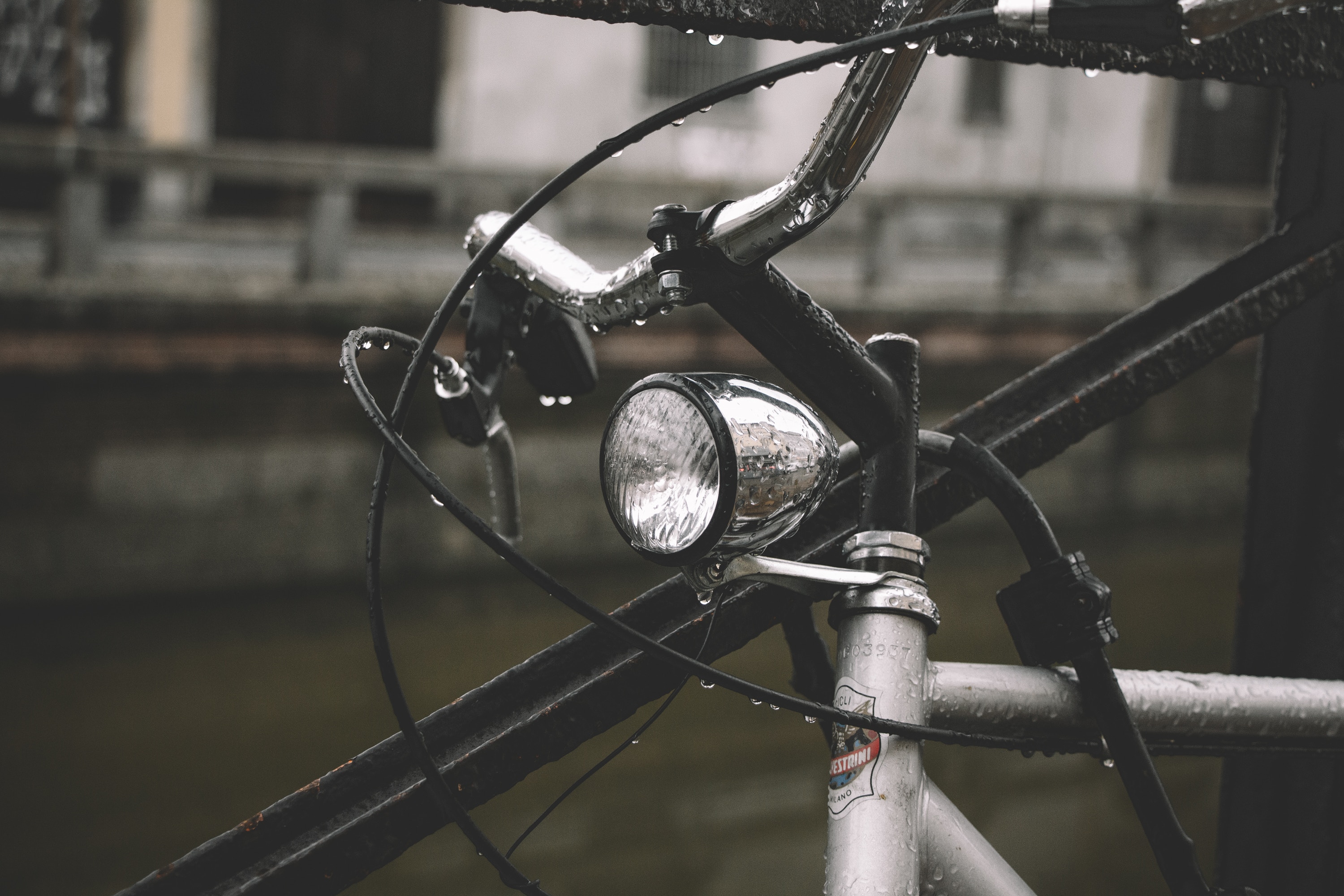 Wet bicycle with a chrome headlight on a rainy day HD Wallpaper