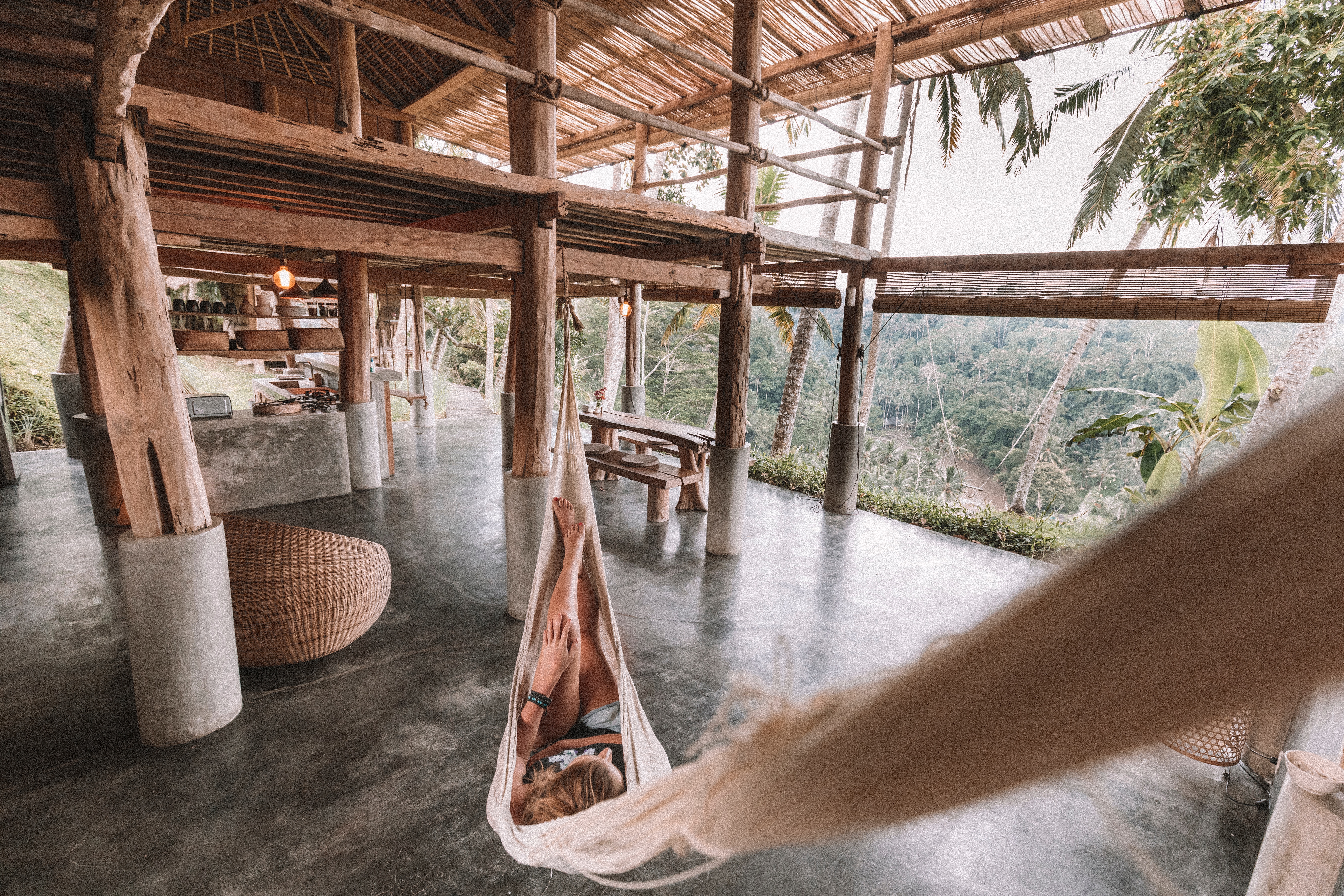 Woman relaxing in a hammock overlooking a jungle in Ubud HD Wallpaper