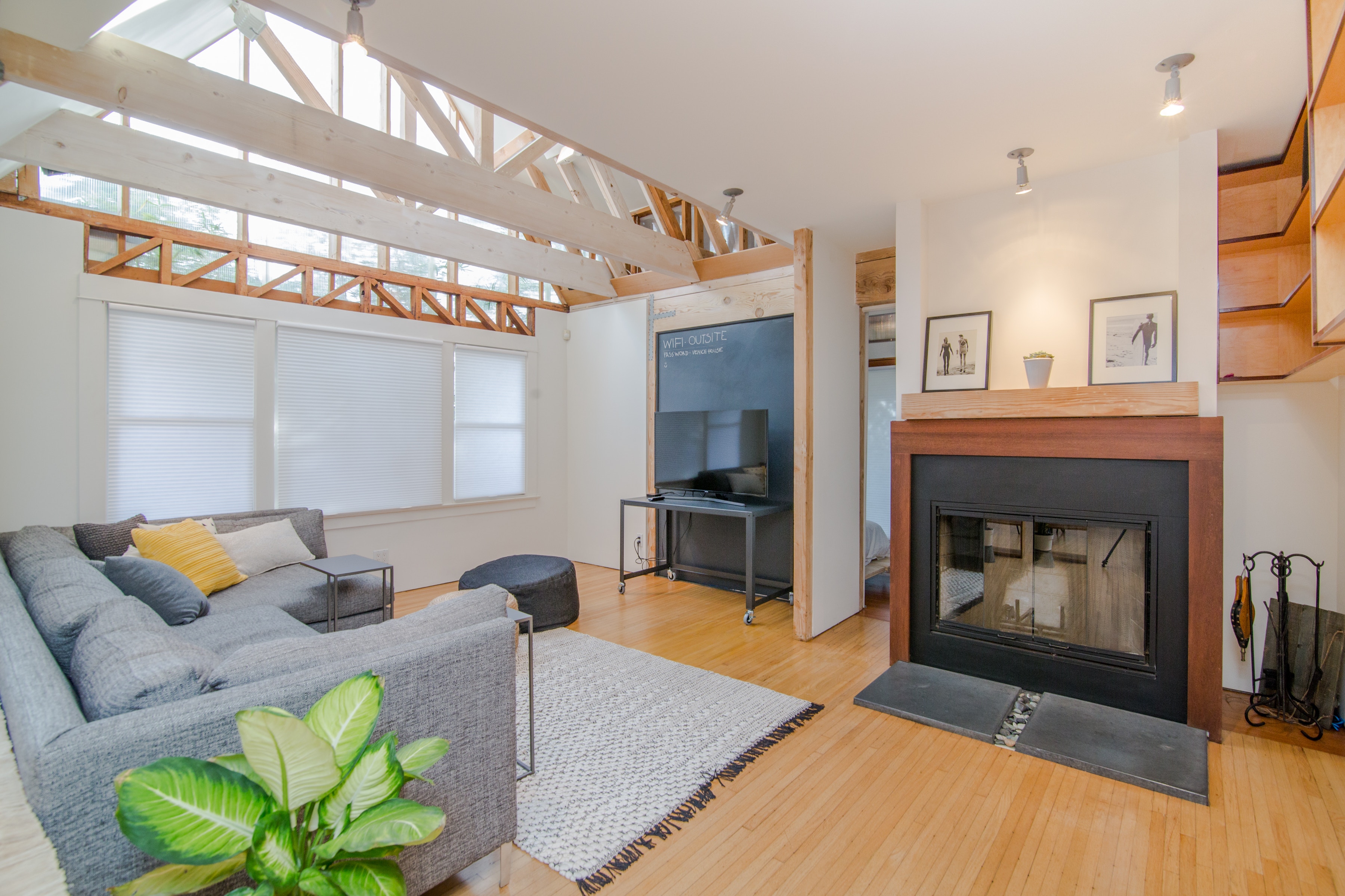 Living room with fireplace, sofa, and exposed beams HD Wallpaper