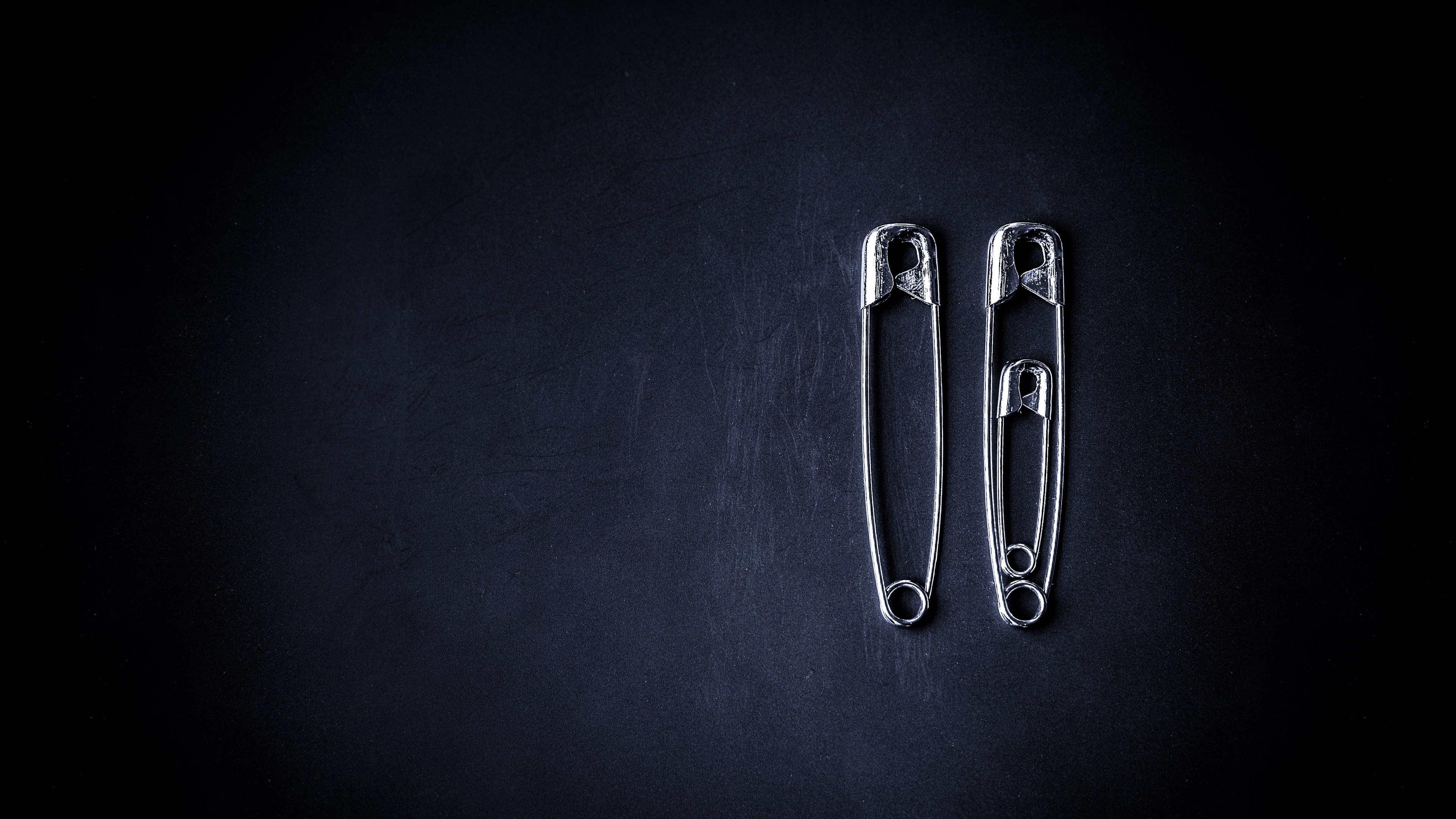 Three safety pins on a dark background HD Wallpaper