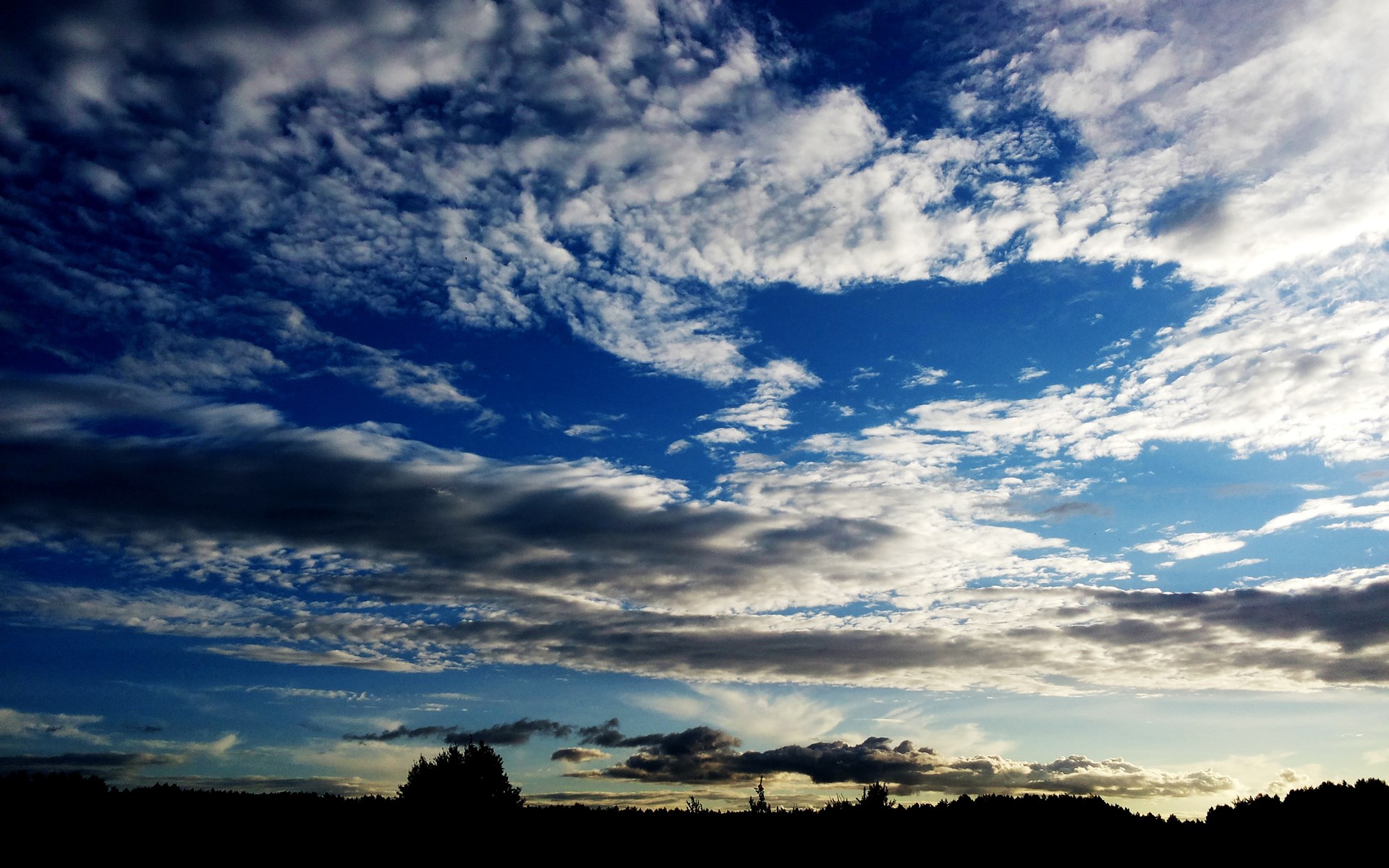 Dramatic Sky with Clouds Over Silhouetted Landscape HD Wallpaper