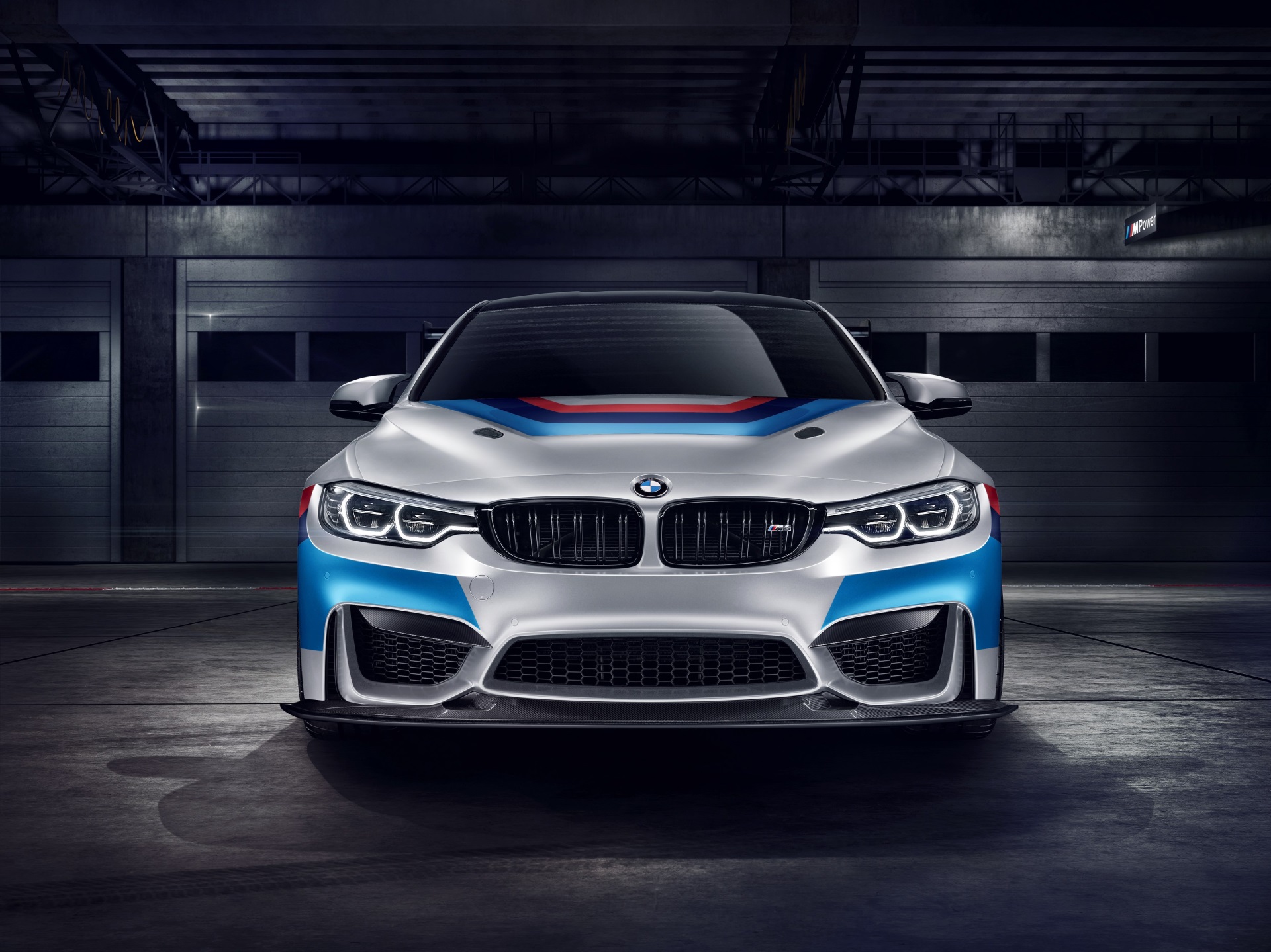 BMW M4 GT4 race car in garage HD Wallpaper