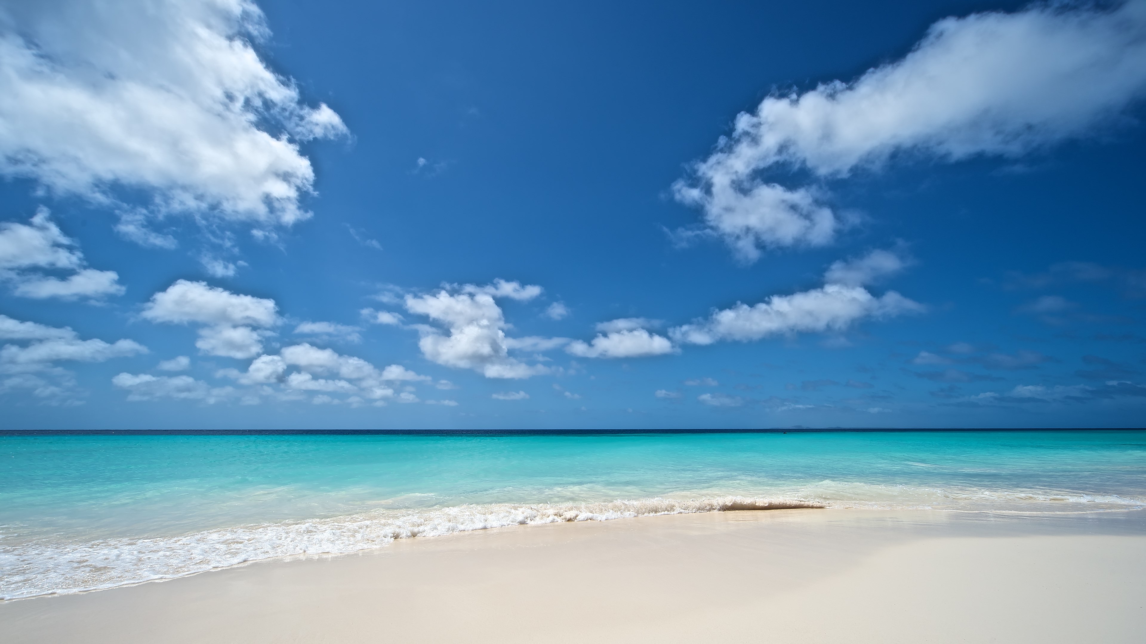 Turquoise ocean and white sand beach with clouds HD Wallpaper