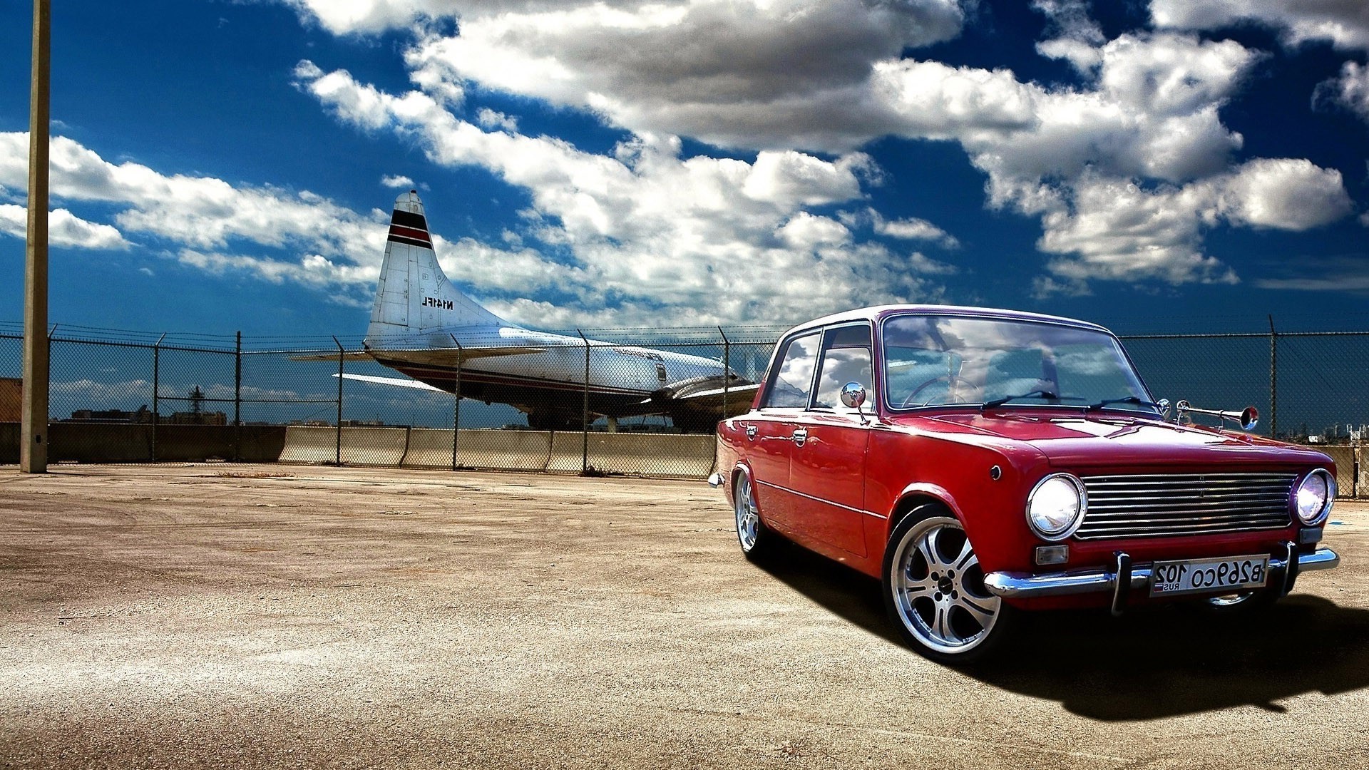Red Lada 2101 car parked near an airplane HD Wallpaper