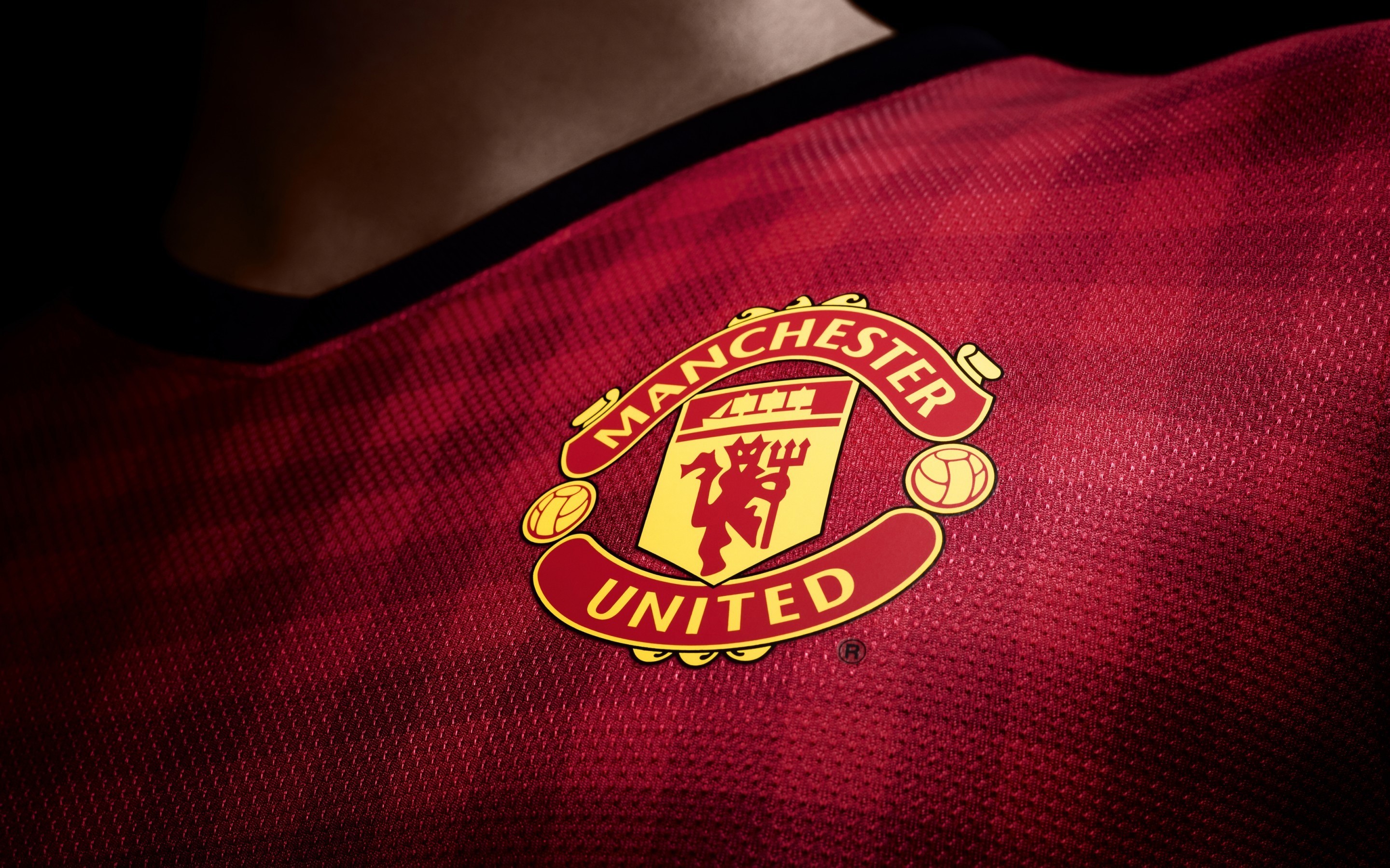 Manchester United logo on a red jersey HD Wallpaper