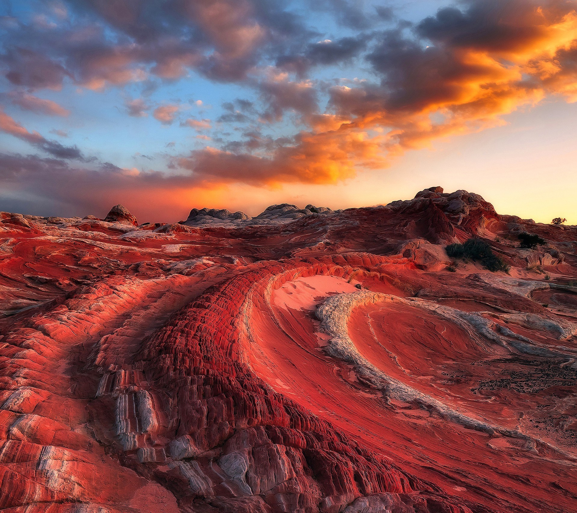 Red rock formations at sunset with colorful clouds HD Wallpaper
