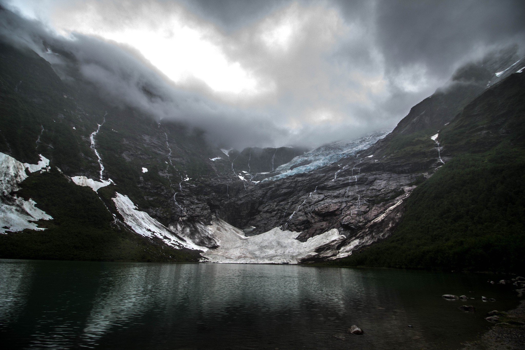 Glacier and lake under dark clouds in Norway HD Wallpaper