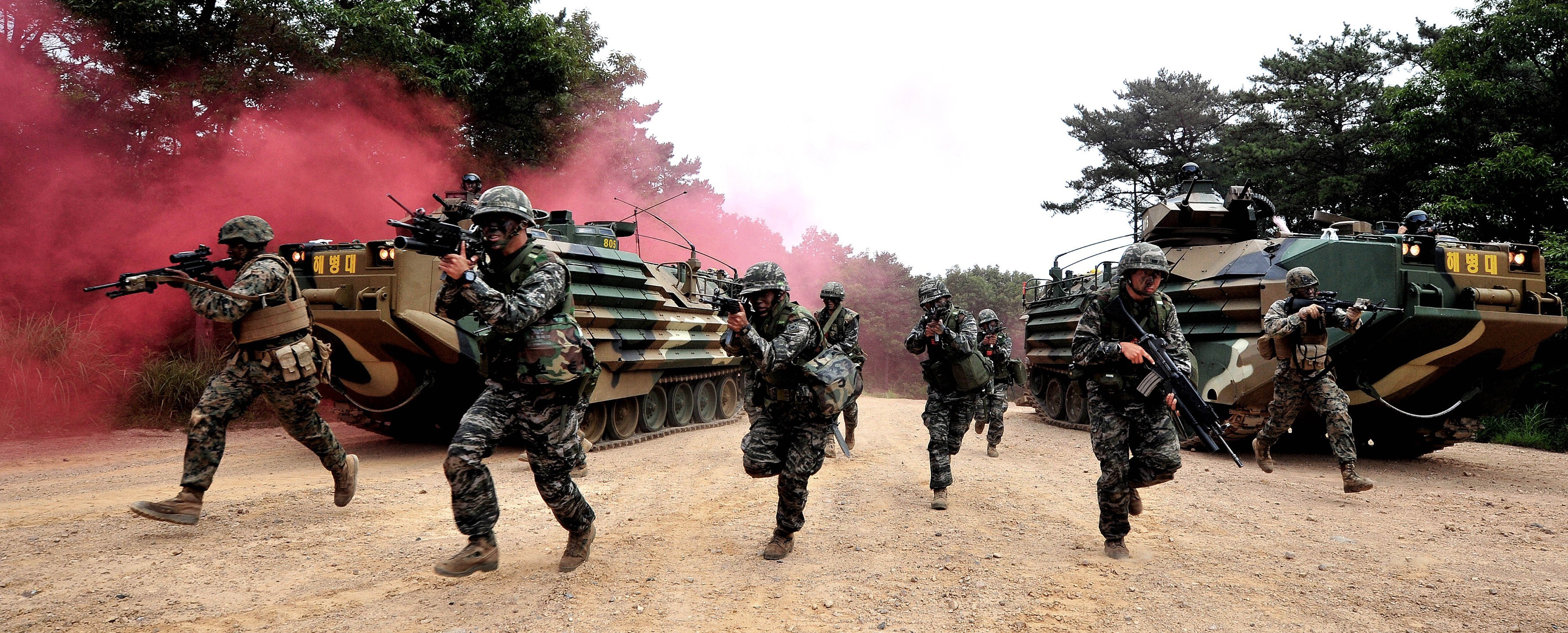 South Korean soldiers advance with armored vehicles and smoke HD Wallpaper