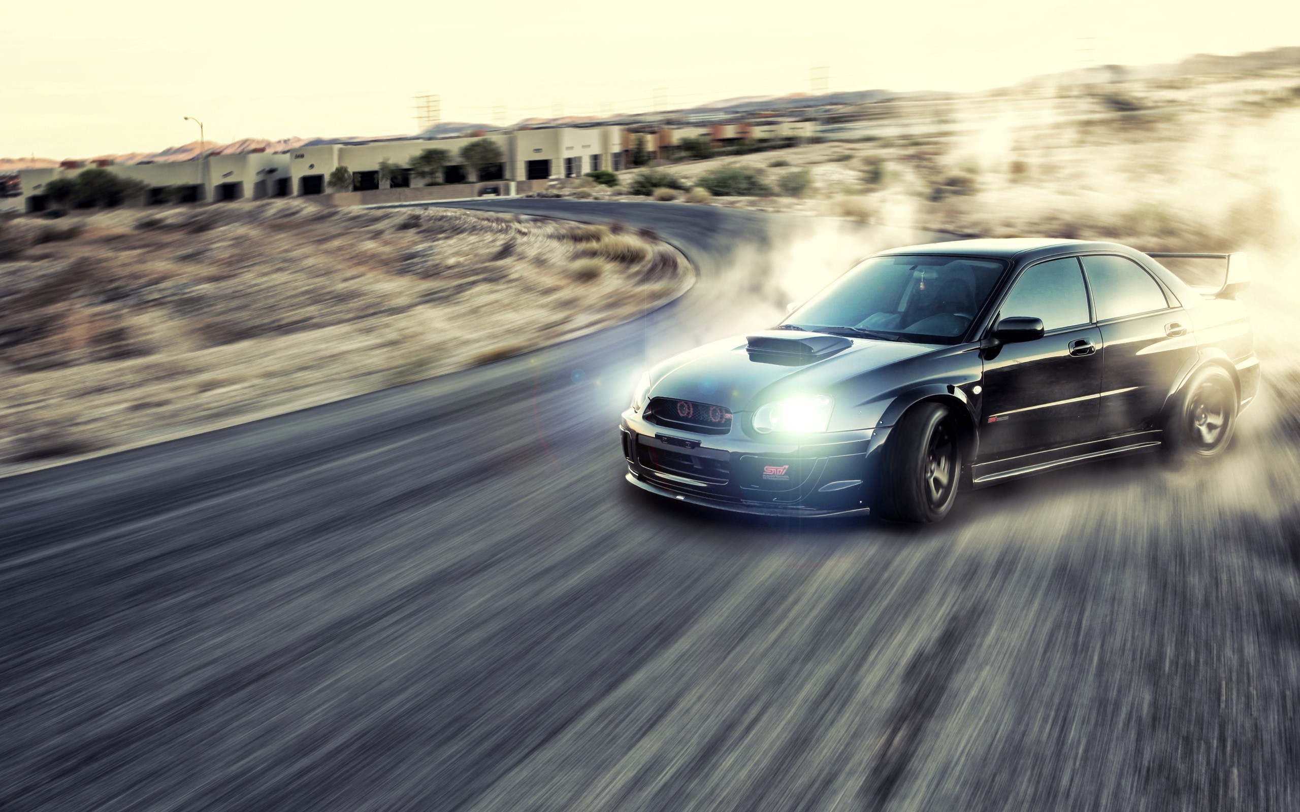 Black Subaru WRX STI drifting on a desert road HD Wallpaper