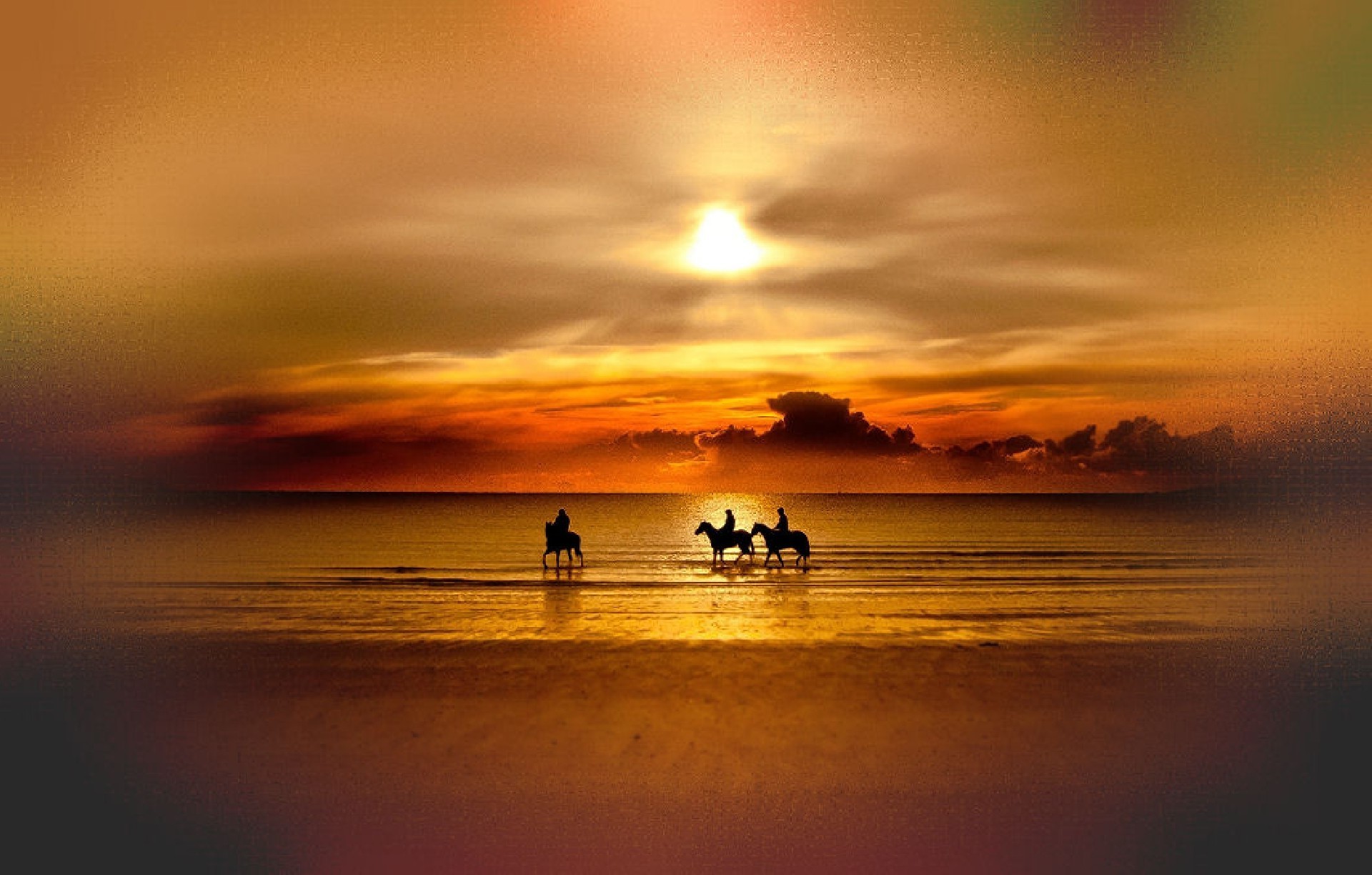 Three people on horseback at sunset over the water HD Wallpaper