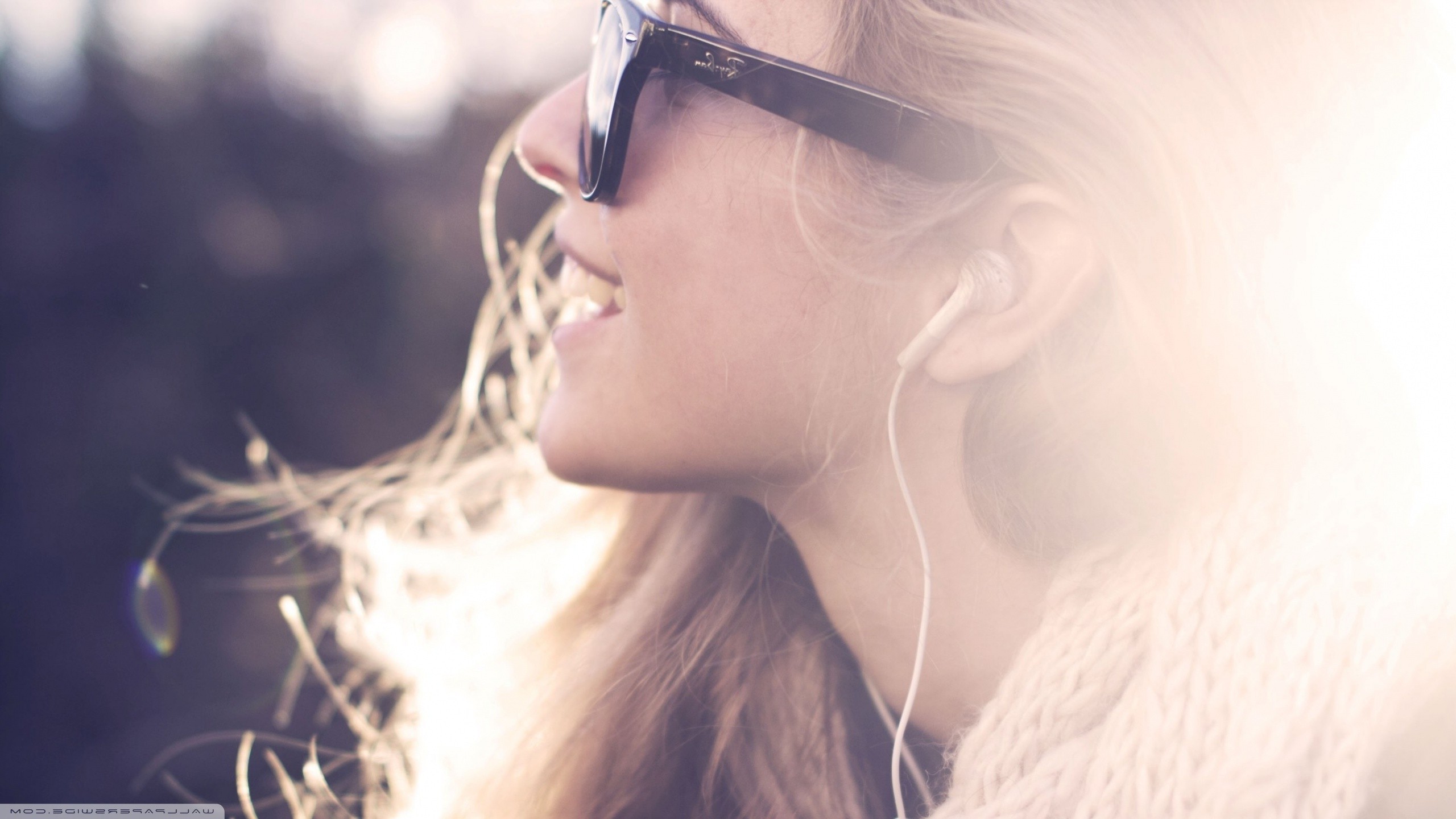 Woman wearing sunglasses and earphones listening to music HD Wallpaper