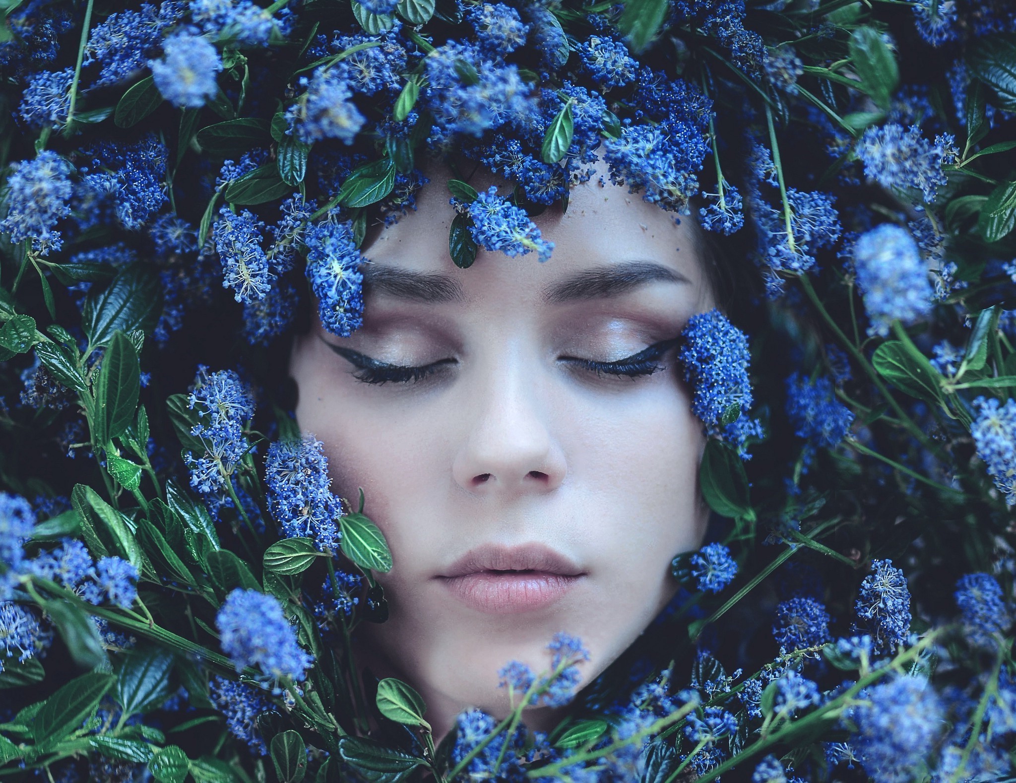 Woman with blue flowers covering her face HD Wallpaper