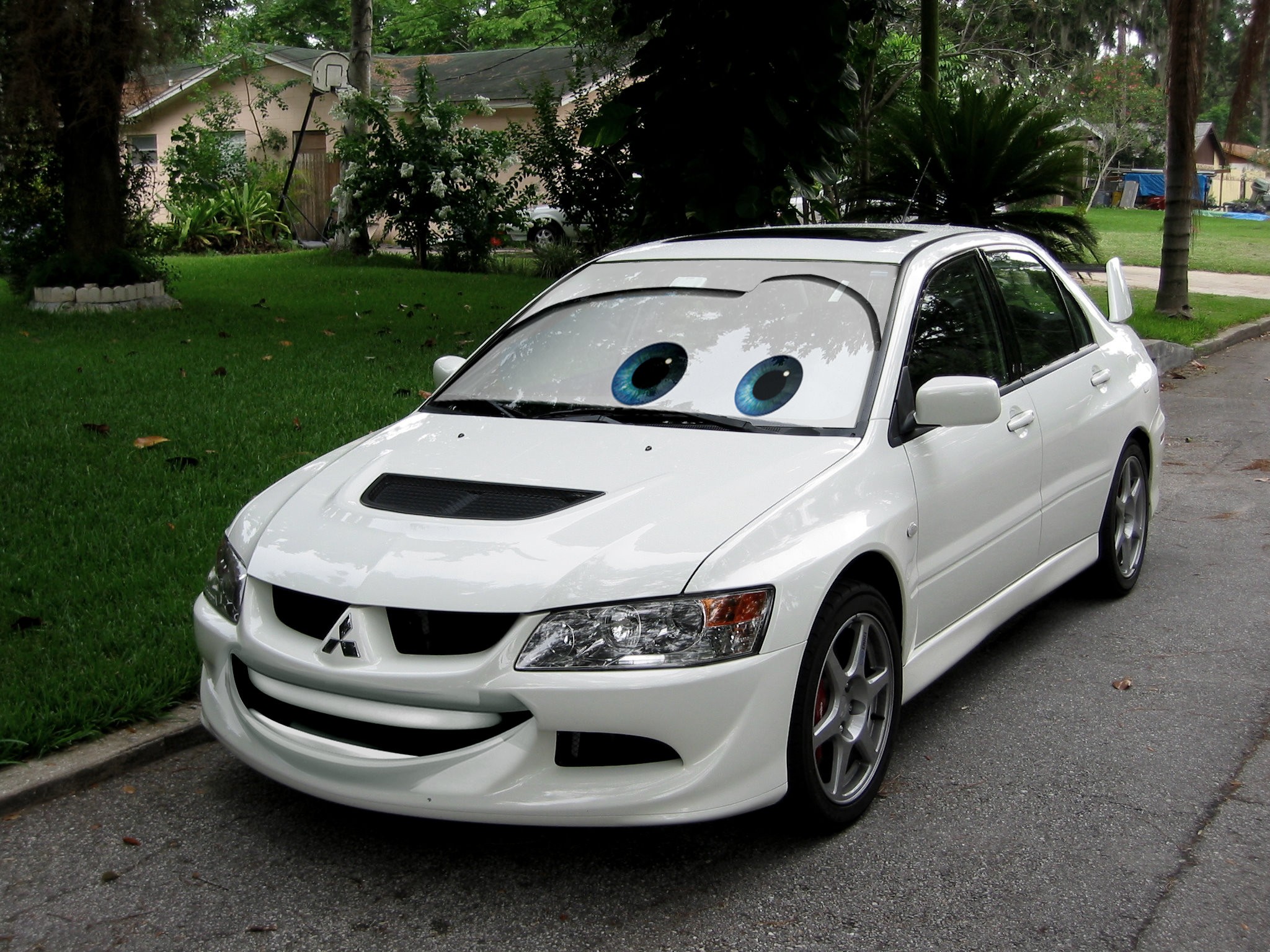 White Mitsubishi Lancer Evolution with cartoon eyes HD Wallpaper