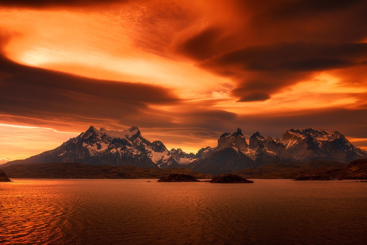 Amber sunset over snowy mountains and lake in Torres del Paine HD Wallpaper