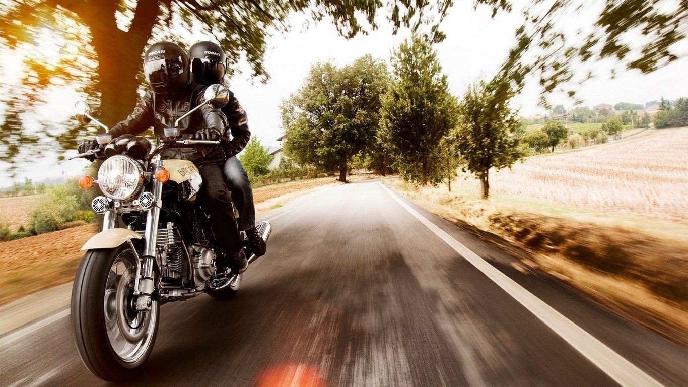 Couple riding a motorcycle on a country road HD Wallpaper