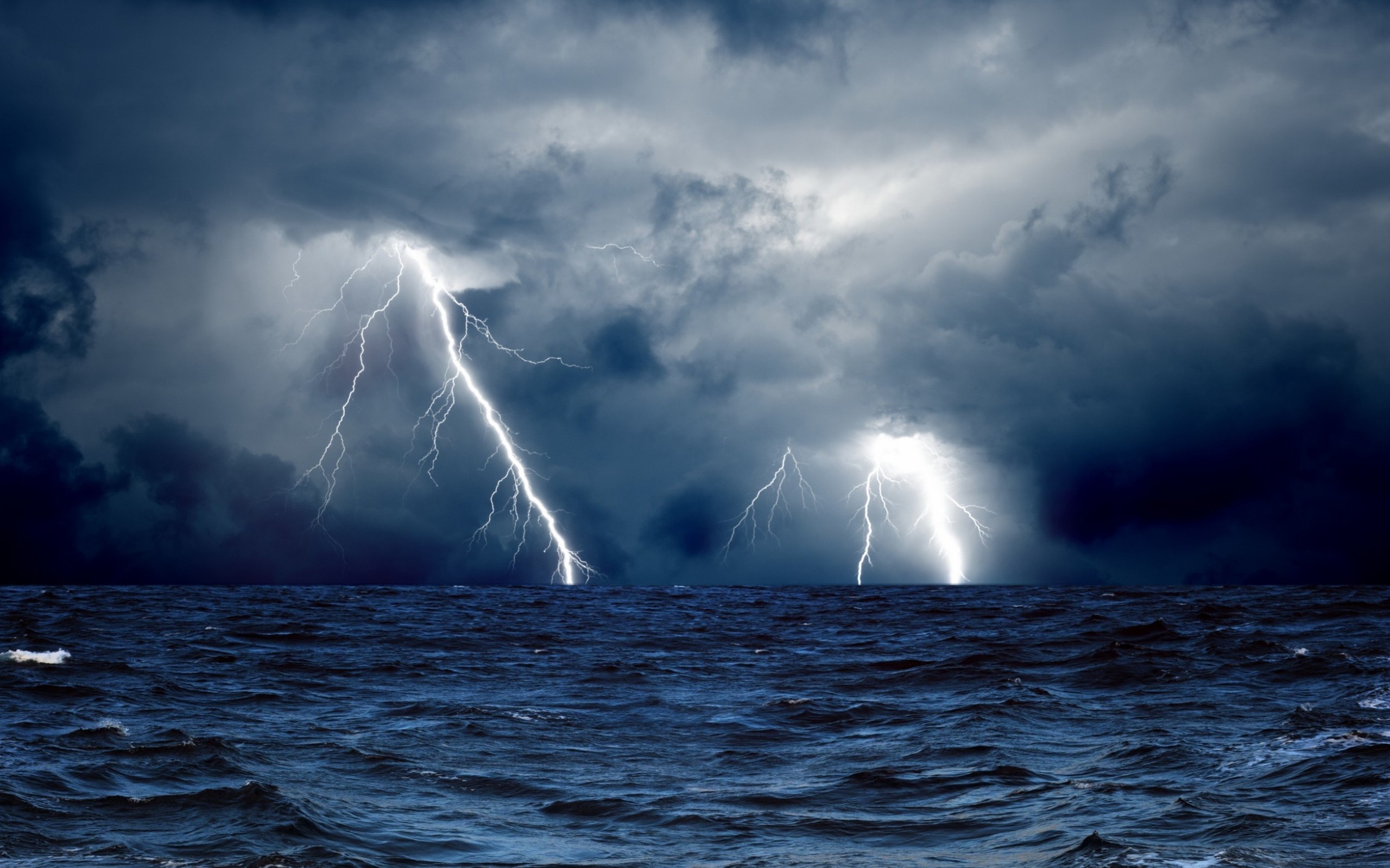 Lightning strikes over a stormy sea HD Wallpaper