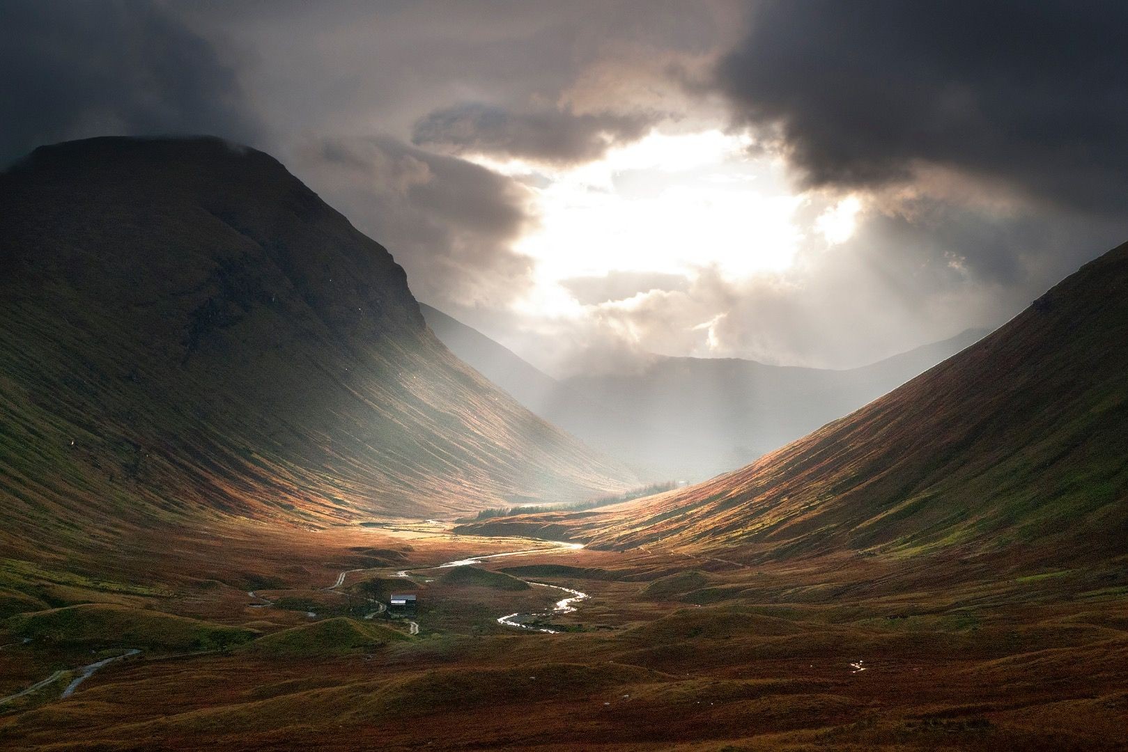 Valley with river and mountains under dramatic sunlight HD Wallpaper