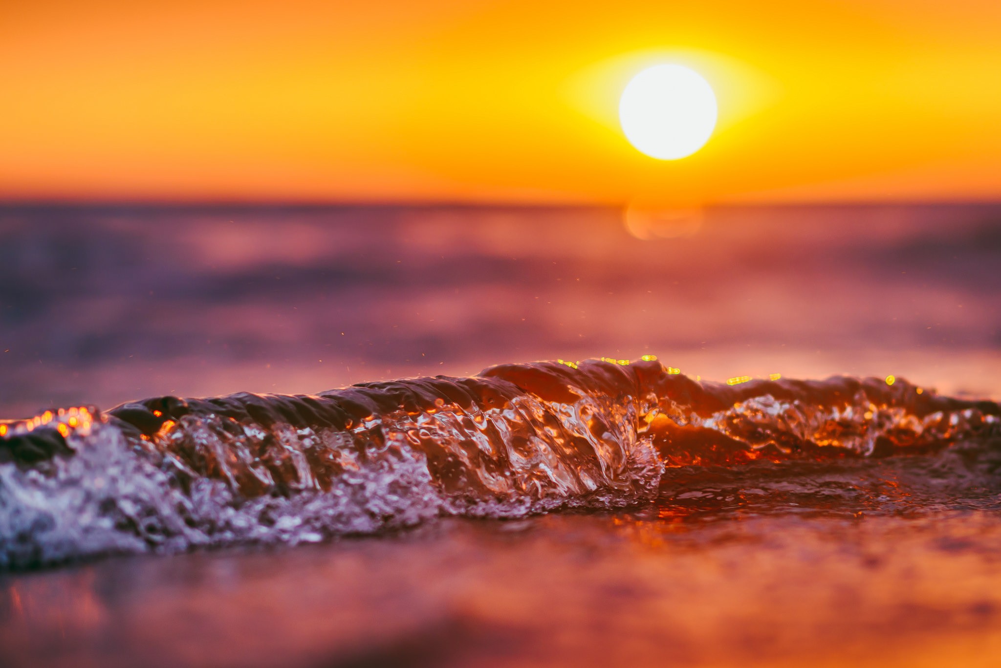 Sunset over the ocean with a wave HD Wallpaper