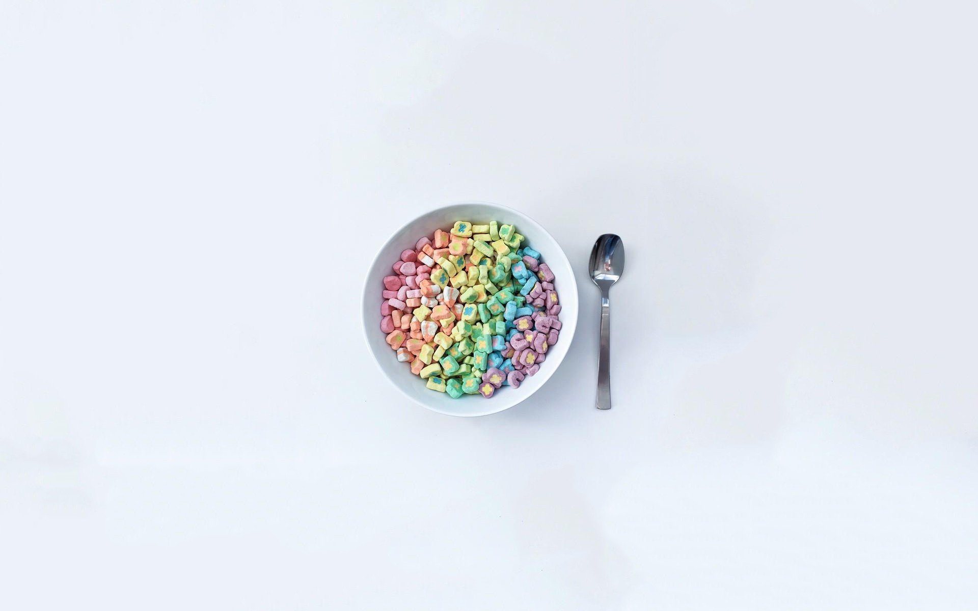 Bowl of rainbow Lucky Charms marshmallows with spoon HD Wallpaper
