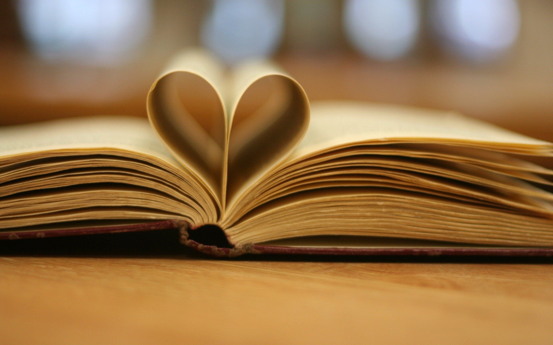 Open book with pages forming a heart shape HD Wallpaper