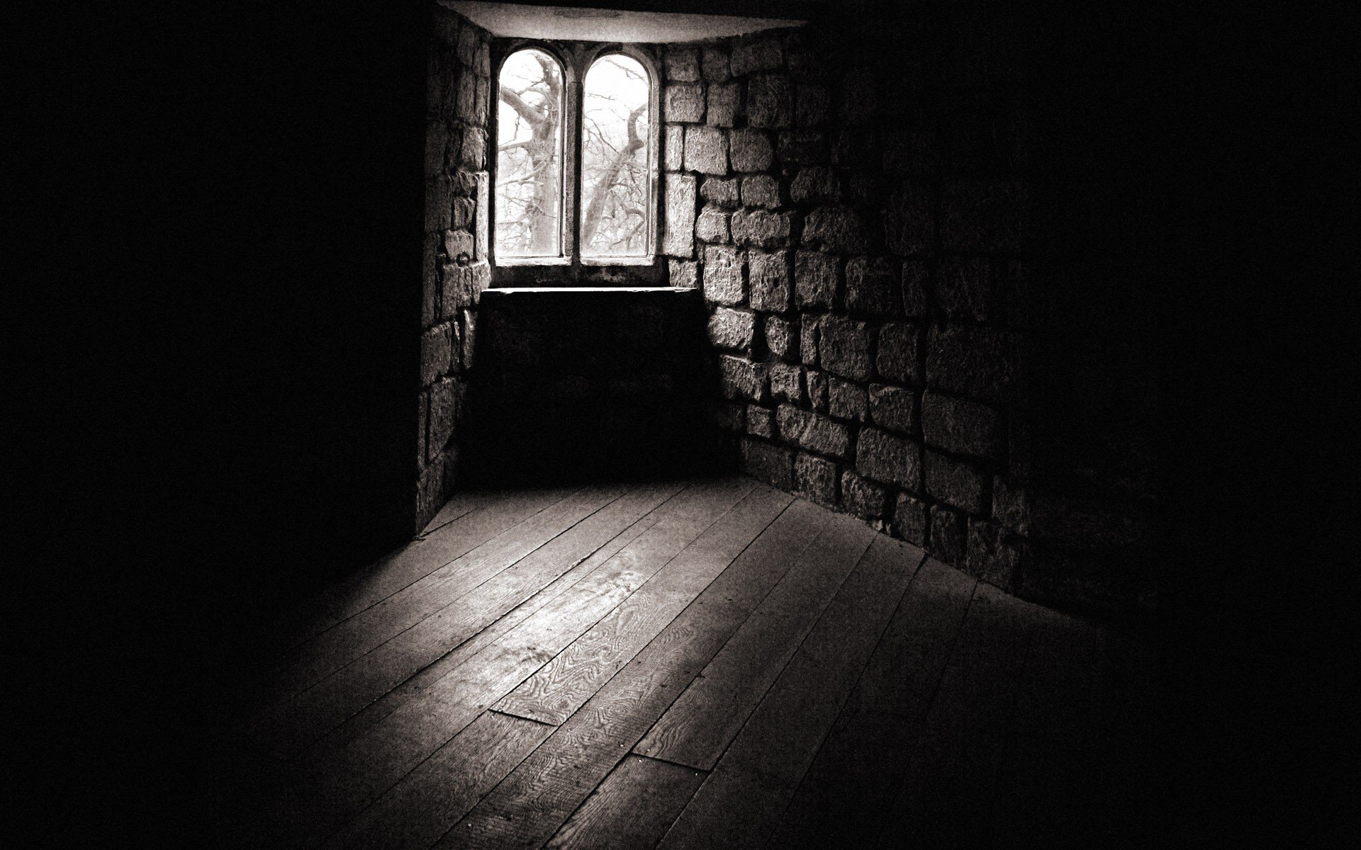 Dark room with stone walls and wooden floor HD Wallpaper