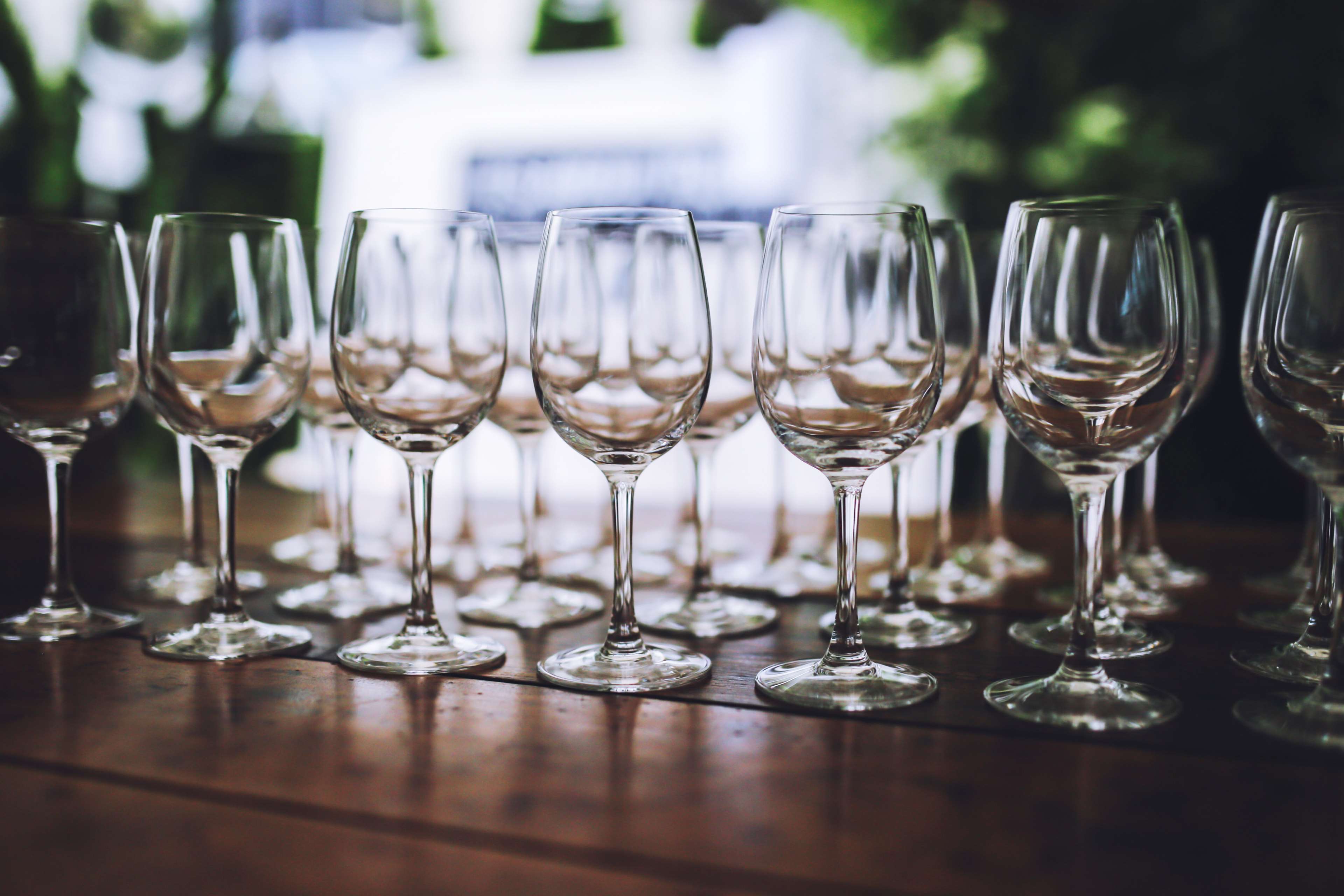 Empty wine glasses on a wooden table HD Wallpaper