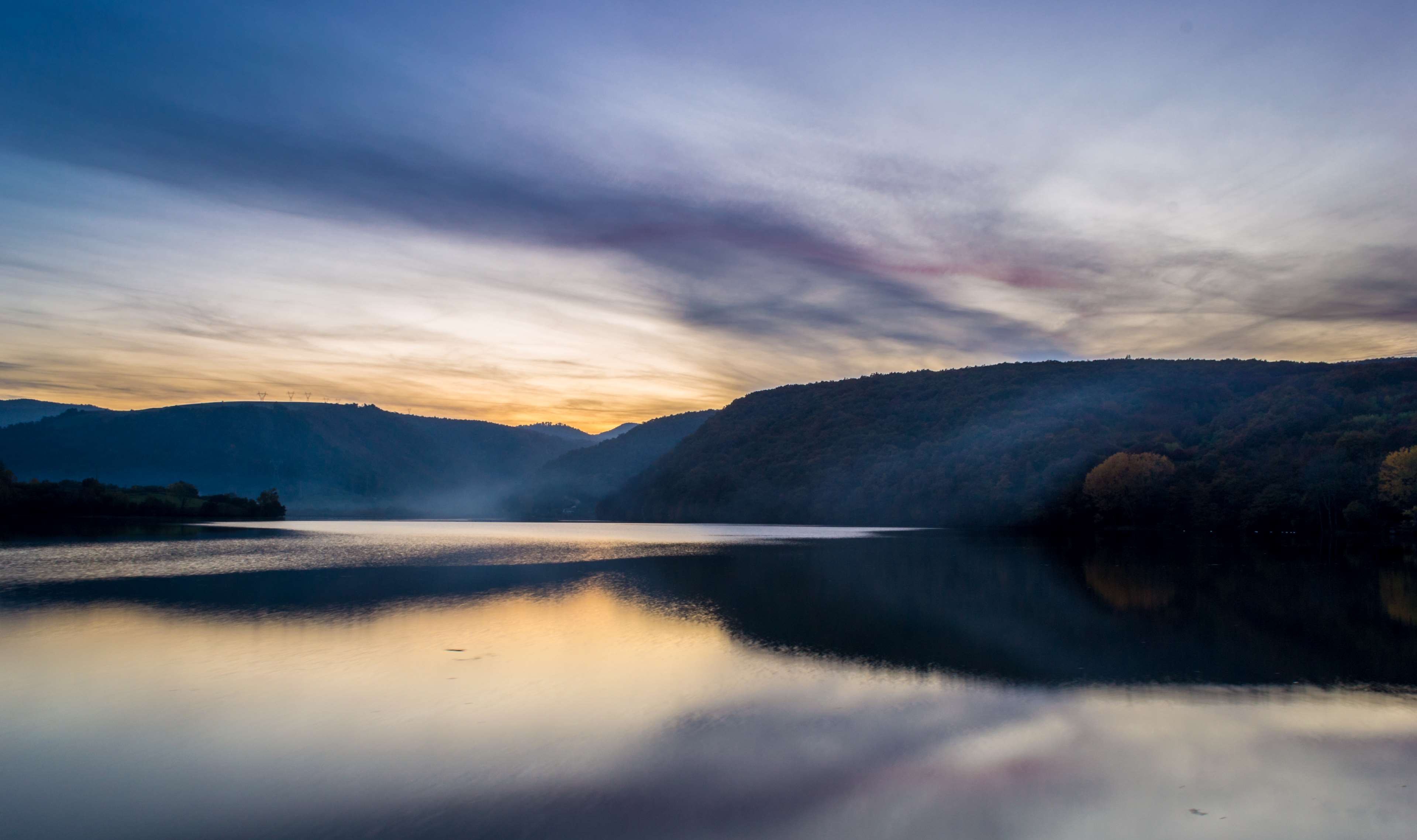 Sunset over a misty lake and mountains HD Wallpaper