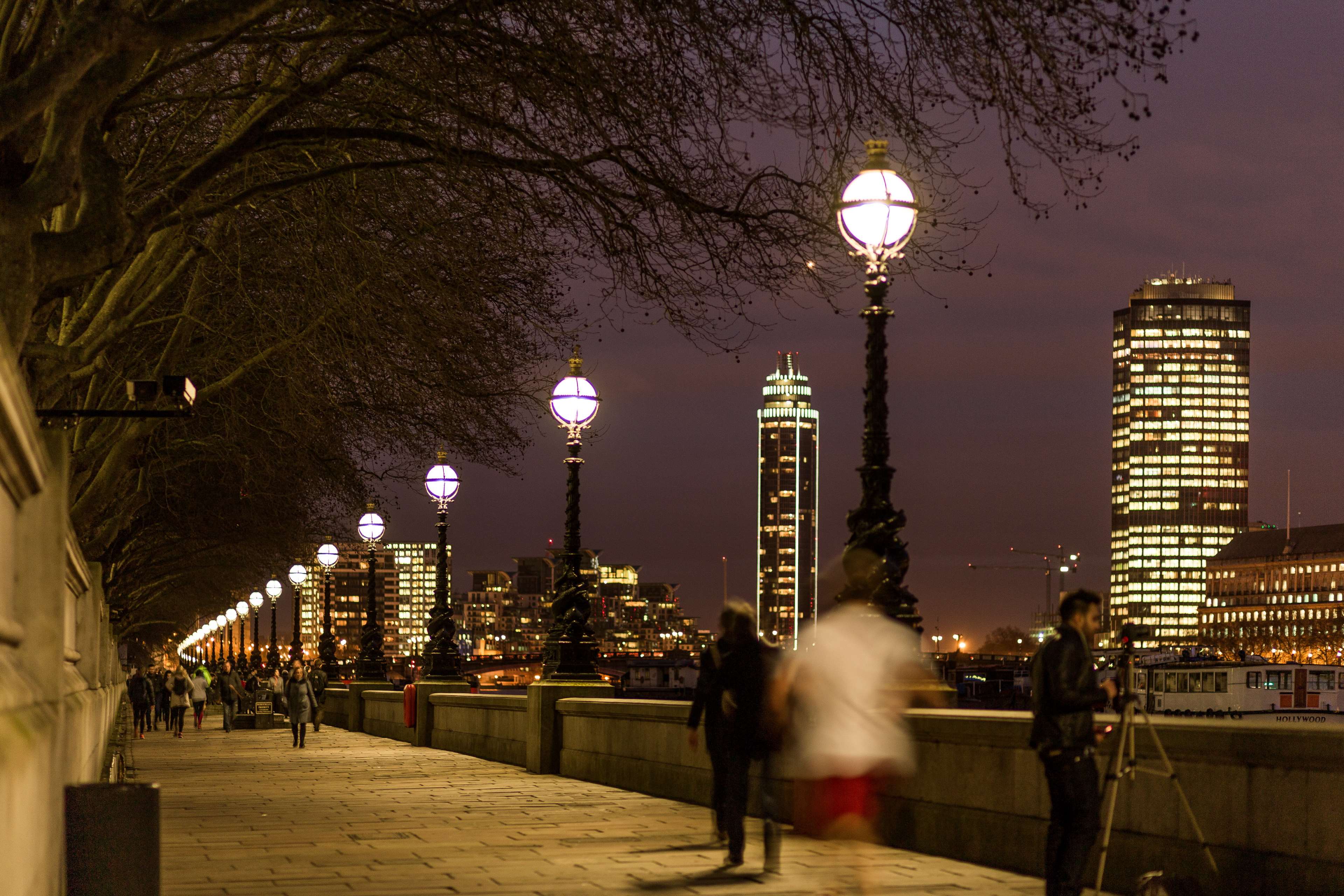 Night walk along the river with city lights HD Wallpaper