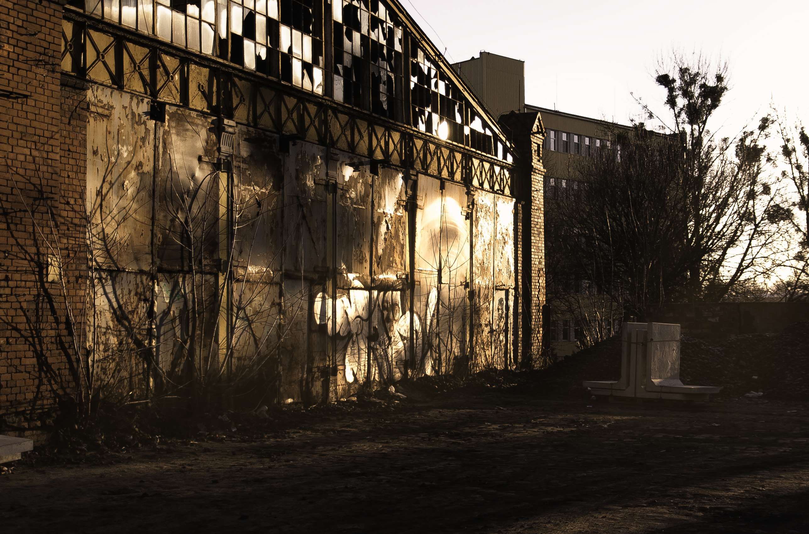 Abandoned industrial building with broken windows at sunset HD Wallpaper