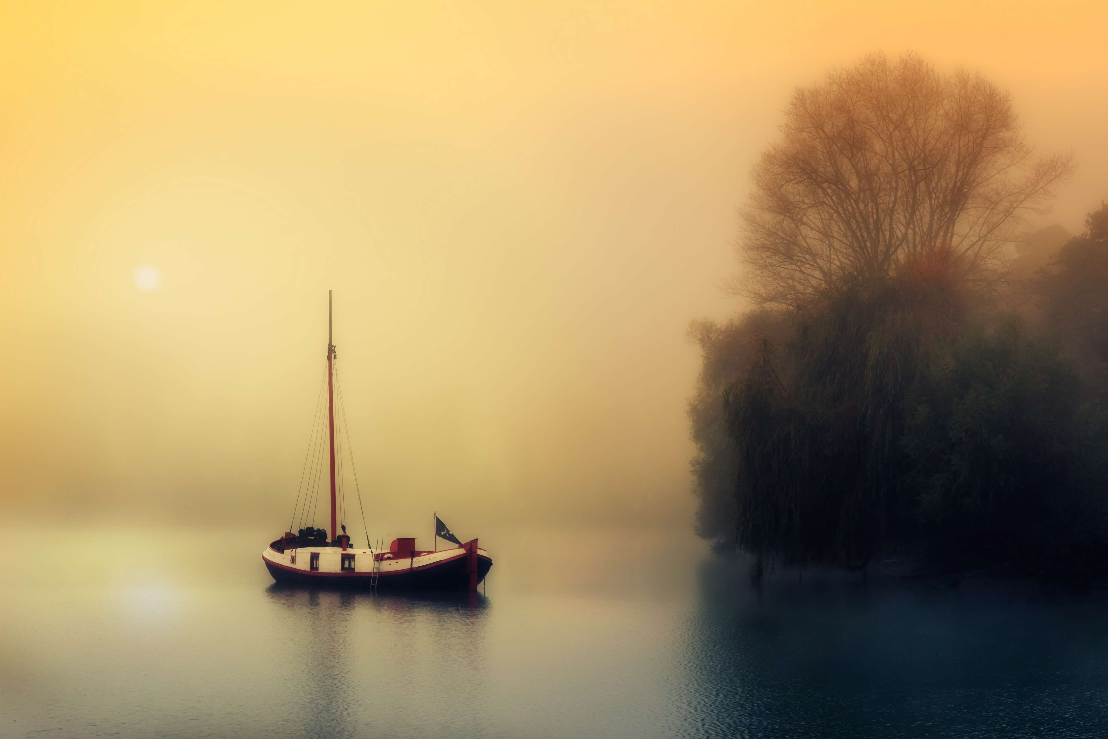 Sailboat on a foggy lake at sunrise HD Wallpaper