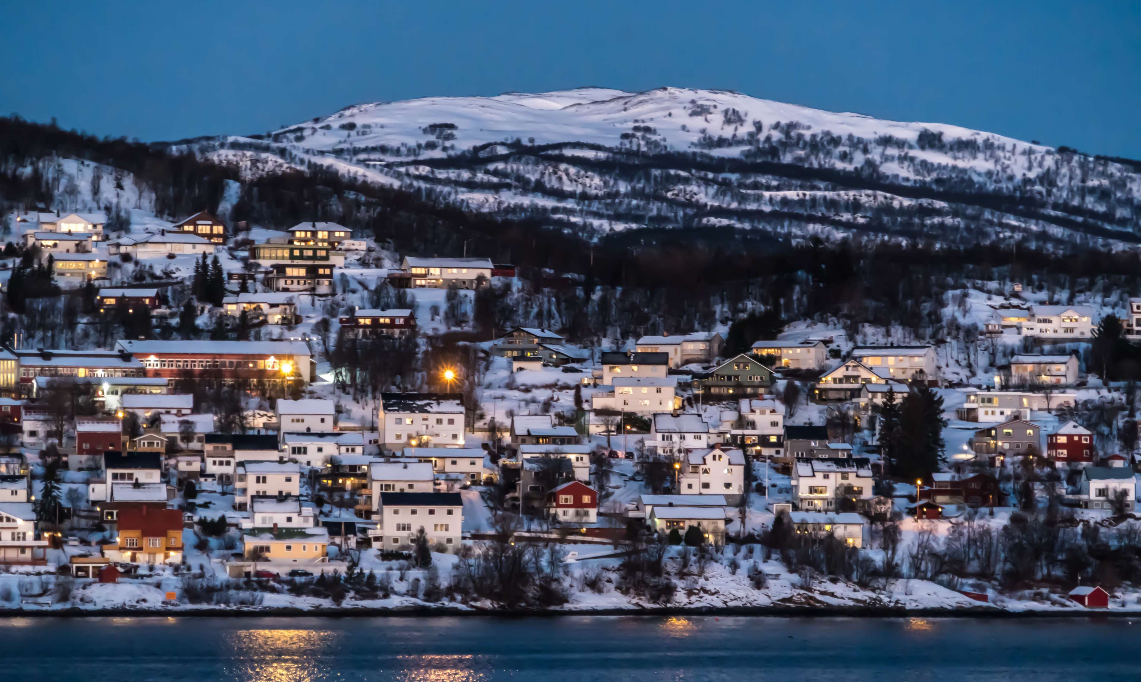 Snowy village on a mountain overlooking the sea in Norway 4K HD Wallpaper