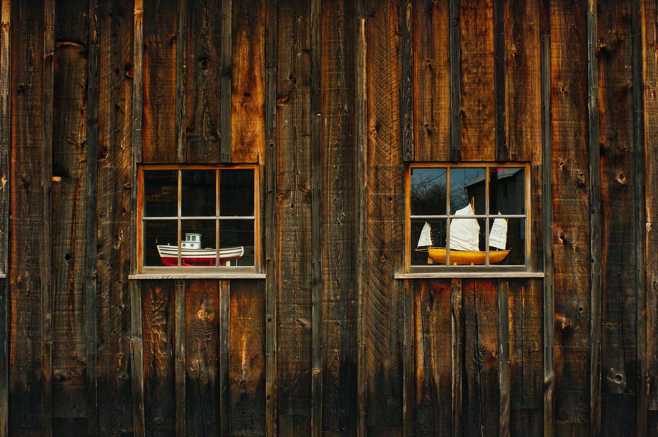Two windows with model boats on a wooden wall HD Wallpaper
