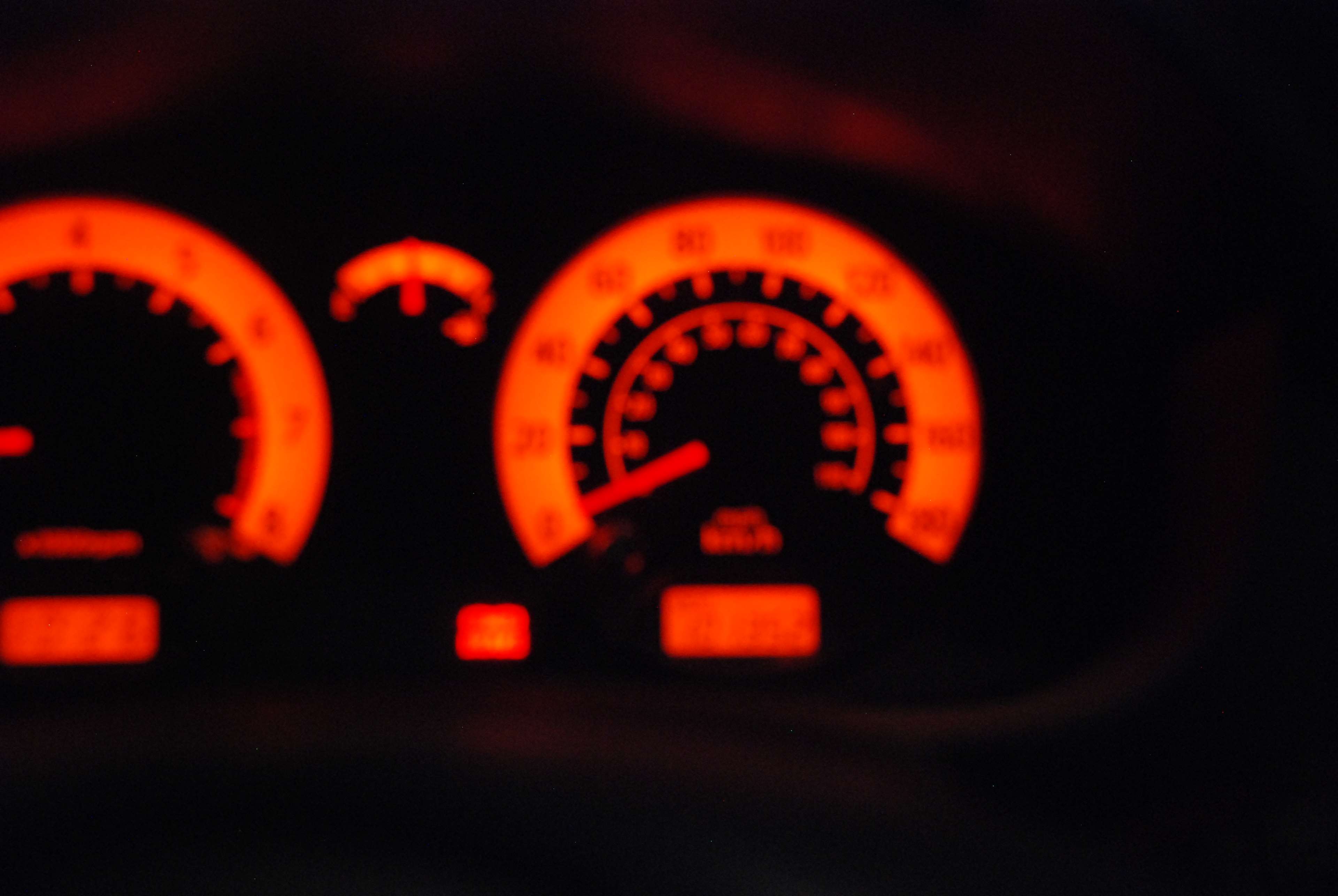 Car dashboard with orange illuminated gauges HD Wallpaper
